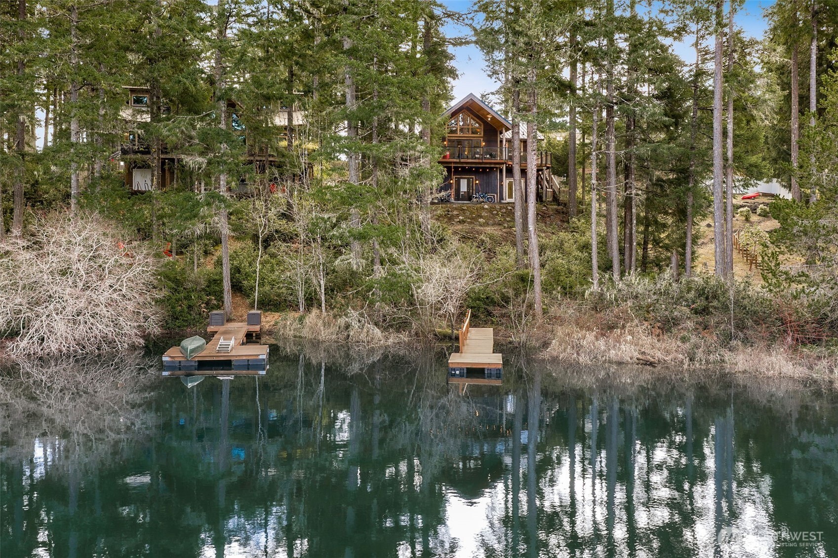 Custom-built contemporary home in the Emerald Lake community, offering modern style, quality construction, and a peaceful lake-area setting in Grapeview. Built in 2023, this thoughtfully designed 3-bedroom, 1.75-bath home offers 2,448 sq ft of living space with vaulted ceilings, a spacious and open feel, and stylish finishes throughout. The functional 1 story-with-basement layout provides flexibility for everyday living, entertaining, or working from home. Set on a .4 Acre lot, the property also features a deck, high-speed internet, and covered parking. Located in the Emerald Lake Community Club, residents enjoy access to amenities including a boat launch, park, playground, and trails, bringing recreation and convenience right into the neighborhood. Whether you're looking for a full-time residence or a getaway property, this home offers the perfect blend of comfort, design, and Northwest lifestyle. Enjoy the beauty of Mason County and the appeal of a newer custom home in a desirable community near the water.