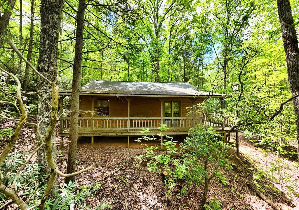 MOTIVATED SELLER! Private 4.75-Acre Mountain Retreat — Endless Potential Awaits. Discover the charm and possibility of this 2-bedroom, 2-bath cabin tucked away in the peaceful Fortenberry Creek subdivision in the sought-after Owl Town area. Set on 4.75 acres—including three additional lots—you'll enjoy unmatched privacy, room to expand, or the option to build additional homes. This rustic mountain retreat is a true diamond in the rough, ready for your personal touch. Whether you're seeking a cozy weekend getaway, full-time residence, or investment opportunity, this fixer-upper offers a rare chance to craft your own mountain escape. The home features a small outdoor building for extra storage, while the surrounding acreage invites dreams of tranquil outdoor living spaces. Surrounded by serene natural beauty, yet just minutes to Blairsville's charming shops, dining, hiking trails, and lakes, this property offers the perfect balance of seclusion and convenience. Bring your vision and creativity — this is your opportunity to transform a hidden gem into something truly special!