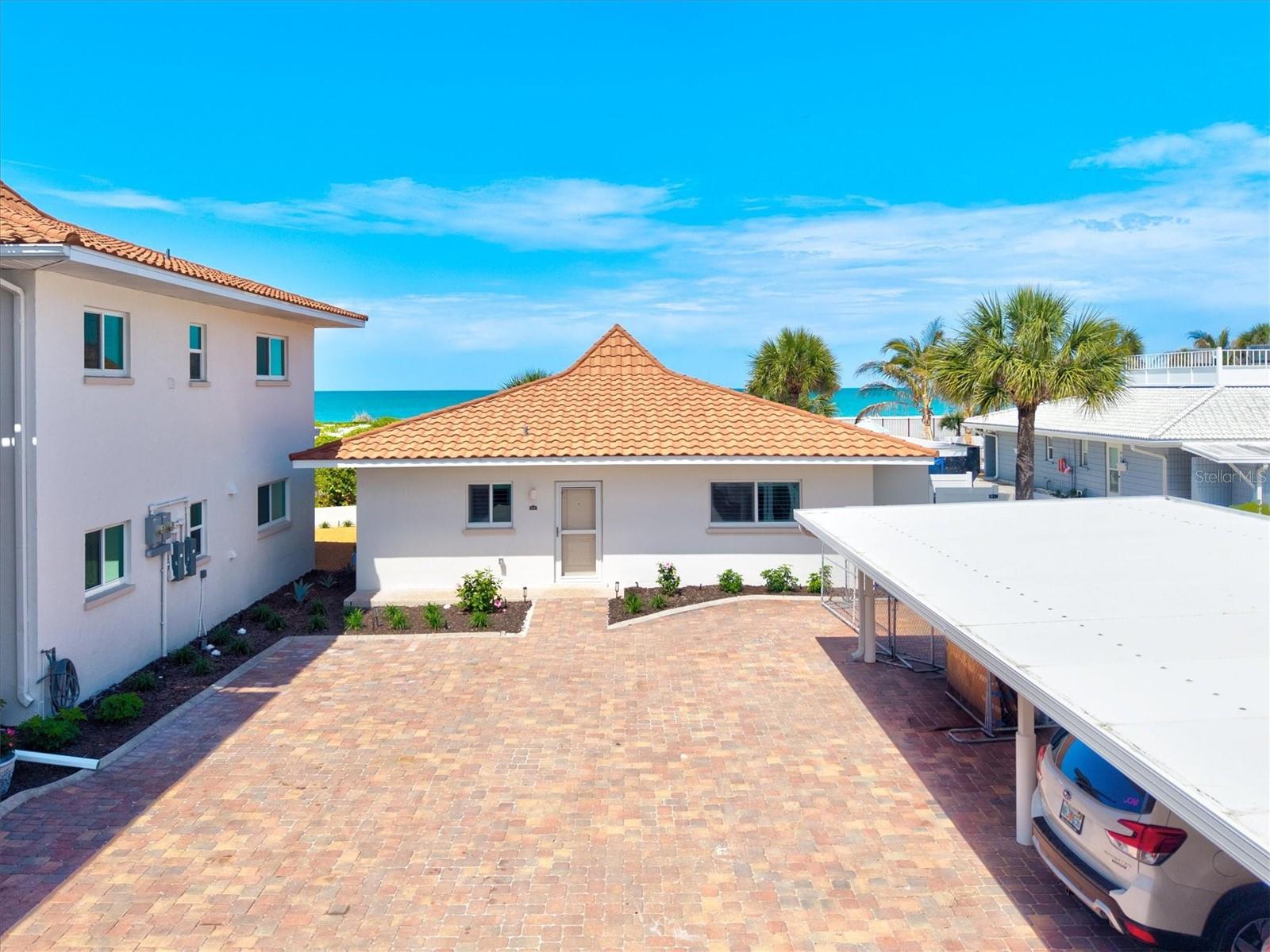 One or more photo(s) has been virtually staged. Villa Chateaugay – A Rare Gulf-Front RetreatExperience a truly exceptional opportunity to own a one-of-a-kind Gulf-front villa that lives like a private single-family home while offering the effortless, maintenance-free lifestyle of condominium living. Perfectly positioned within a welcoming and socially vibrant beachfront community, this beautifully remodeled residence is a rare gem.Villa 1 is the only standalone, single-story residence in the complex - offering the privacy and feel of a Gulf-front single-family home. With over 1,300 square feet of thoughtfully designed living space, this fully renovated villa features a private entrance, open-concept floorplan, and an abundance of natural light throughout. Hurricane-impact windows and doors, plantation shutters, and serene peek-a-boo Gulf views framed by coastal dune foliage create an inviting and tranquil atmosphere.The heart of the home is a stunning, modern kitchen designed for both everyday living and entertaining. Outfitted with 42-inch solid wood cabinetry, full-extension dovetail drawers, soft-close hardware, quartz countertops, stainless steel appliances, and a tasteful contrasting island, it seamlessly flows into the living space. A blue glass tile backsplash and closet pantry add both style and functionality.The spacious primary suite offers a peaceful retreat with direct access to the air-conditioned sunroom and a private screened porch - perfect for enjoying coastal breezes. The en-suite bath is discreetly tucked away, providing comfort and convenience, while a generously sized walk-in closet houses a full-size stacked washer and dryer, an uncommon luxury in condominium living.Nearly every inch of this villa has been meticulously updated, including water and sewer lines, HVAC system, impact glass windows and doors, new appliances, flooring, trim, solid-core doors, hardware, and all plumbing and lighting fixtures. Additional enhancements such as fresh neutral paint, motorized sunshades in the sunroom, plantation shutters, and an exterior storage room complete the home.Chateaugay is a well-managed and beautifully maintained community known for its friendly atmosphere and engaging lifestyle. Residents enjoy sunset gatherings, relaxing around the heated community pool, and other community activities. This well-maintained community enjoys newer roofs and carports, freshly painted buildings, upgraded landscaping, and attractive paver parking lots. Perfect location - just a short walk to the Venice Yacht Club, Freedom Boat Club, and Crow’s Nest.Villa Chateaugay offers the rare combination of Gulf-front, single-family-style living at a fraction of the price, blended seamlessly with the ease and peace of mind of condominium ownership. Isn’t it time to experience life at the beach in a place this special?