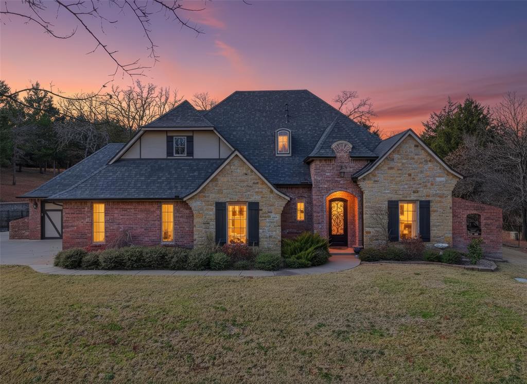 This stunning 2,776 sq ft brick & stone home is tucked away in a quiet cul-de-sac. Upon entry, you are welcomed by soaring ceilings & a grand staircase, setting the tone for the impressive layout. A spacious study with custom built-ins, tray ceiling & built-in dresser provides a flexible space.The living room features warm laminate flooring, a gas fireplace with stone surround, built-in cabinetry & a tray ceiling that adds architectural interest. The primary suite is conveniently located on the lower level, offering privacy.  Offers a soaking tub, large walk-in shower with bench, double sinks & generous closet space. An additional half bath is also located on the main level for guests.Upstairs, you’ll find two bedrooms connected by a Jack-and-Jill bathroom with a tub/shower combination, along with a versatile game room that could serve as a fourth bedroom, with a unique hidden bookshelf door. An oversized landing upstairs offers space for seating & built-in desk.The kitchen is designed for both everyday living & entertaining, featuring a gas cooktop, double ovens, true ventilation, pantry, vegetable sink, main sink & a custom island nook. The dining room, located just off the kitchen, is filled with natural light and offers backyard views through large windows. The laundry room includes a window, ample storage & is conveniently located near the primary suite. The backyard is truly exceptional, featuring an in-ground saltwater pool with rock accents, waterfall, a covered patio with an outdoor wood fireplace. Built-in grill with countertop, a wood-burning fire pit & family pet fencing. Well on the property. Mature trees, retaining walls & lush landscaping create a private outdoor retreat.  4-car garage with storm shelter (fits 6–8 people), oversized driveway with ample parking, full guttering, sprinkler system, security system & added roof insulation. New roof, gutters & accessories were replaced March 2025.