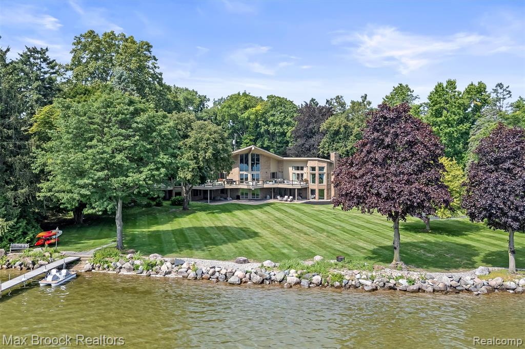 Meander through the Orchard Lake Country Club property to your home on the best street on Orchard Lake. On an exclusive stretch of shoreline, with only fourteen estate-sized parcels on this private, dead-end street. Unparalleled privacy, prestige & panoramic lake views from nearly every room. 3333 W Shore features 2.12 acres & 230’ of lake frontage on 795-acre all-sports Orchard Lake, with picturesque views of Apple Island. Blend of mid-century modern & contemporary design, desirable ranch with finished walkout lower-level offers over 9,200 square feet. Striking architecture, cedar shake roof, vaulted ceilings, floor-to-ceiling windows, skylights, & hardwood floors throughout. Intricate, detailed, solid wood doors & leaded glass doors. The enormous great room is the interior focal point, two-story fireplace. Gourmet granite kitchen, oversized island with counter-top seating for six. Thermador six-burner, plus griddle gas cooktop, double ovens, & wine refrigerator. Luxurious primary suite offering stunning lake views. Dual walk-in closets, coffee bar, over-sized marble shower, sleek stone soaking tub & washer & dryer. Walkout lower level features three en-suites, theater with leather reclining chairs, entertainment area, partial second kitchen. Enormous, mirrored exercise studio with rubber floor, gym lockers & dry sauna. Cedar closet. Three fireplaces. Elevator. 90-foot deck spanning the entire home, glass railing. Steps down to the brick paver patio, offering multiple outdoor entertaining areas. Sports court. Newer mechanicals & some Pella windows.  Large circular driveway for ample guest parking. Three-car attached garage, plus a secondary garage that accommodates six cars with room for lifts, perfect for your boat storage. Private entrance office/in-law/guest suite offers a separate home office, bedroom & full bathroom. Taxes are currently non-homestead. West Bloomfield schools. A rare opportunity to own one of the most coveted addresses on Orchard Lake!