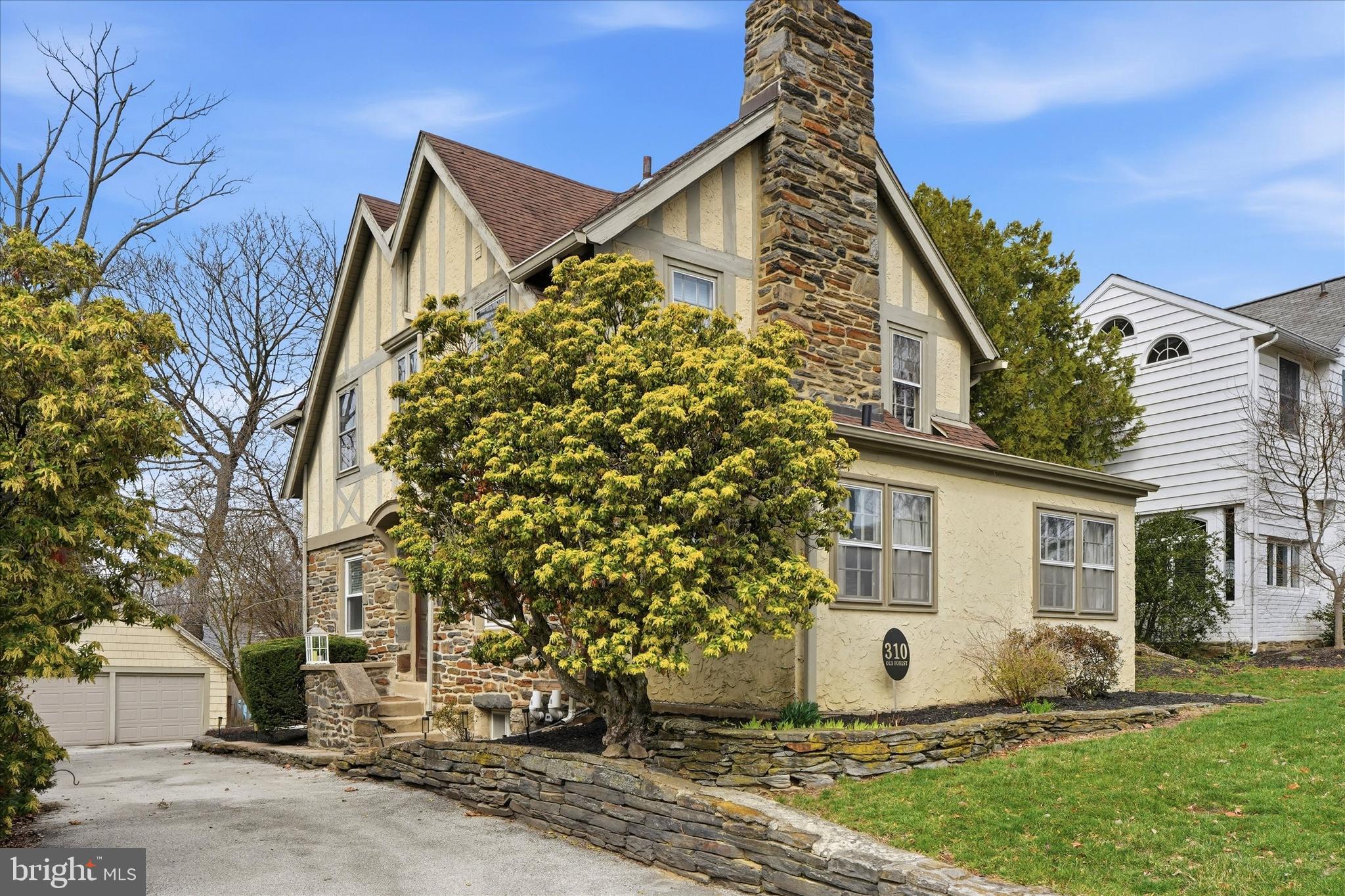 Discover timeless charm and modern comfort in this stunning single-family Tudor at 310 Old Forest Rd., nestled in the heart of Carroll Park section of Wynnewood, PA. From the moment you arrive, the character of this home shines through, while its thoughtfully updated features make it perfectly suited for today’s lifestyle.  The owner has done several upgrades to the home!  Step inside to find a fully updated luxury kitchen renovation that’s as functional as it is beautiful, featuring sleek quartzite countertops, beautiful shaker white cabinetry and all the amenities you could want in a gourmet kitchen. This space was opened up and is thoughtfully designed with a dining area, perfect for both casual breakfasts or hosting memorable formal gatherings. Whether it’s a quiet morning coffee or a lively dinner party, this space is the true heart of the home.  The home offers 3 spacious bedrooms, and for those dreaming of even more space, a large attic awaits your vision—perfect for creating additional bedrooms or a private retreat.  The unfinished basement offers the perfect storage space and the ceiling height is high enough to add an additional room. The cozy family room invites you to unwind by the warmth of a wood-burning fireplace, framed by charming built-ins. Just off this space, you’ll find a versatile bonus room that adapts effortlessly to your needs—whether that’s a home office, playroom, or a quiet corner for relaxation.  A new powder room is perfectly tucked away within this room.  Outside, the allure continues with a private backyard oasis, ideal for entertaining or simply enjoying the serene surroundings. A detached 2-car garage adds convenience, while the home’s location on a peaceful street offers the perfect blend of suburban tranquility and urban accessibility. Commuting is a breeze with easy access to the city and the nearby Norristown train line.  This home blends classic Tudor elegance with modern updates and endless potential. Don’t miss your chance to make it yours!