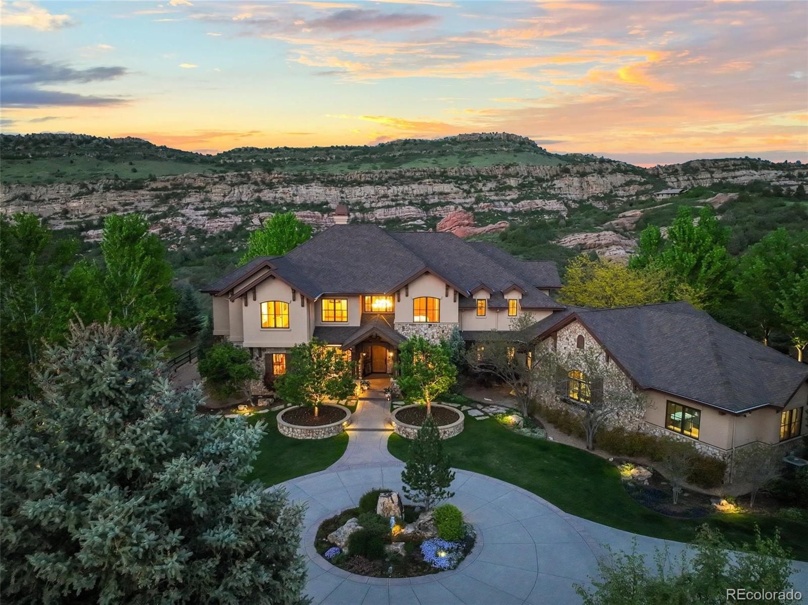 THE CROWN JEWEL! Truly extraordinary MASTER CRAFTED ESTATE W/10 HEATED GARAGE SPACES-complete w/extra carport & wash bay. This rustic contemporary is magnificently poised on nearly 20 PRISTINE EMERALD GREEN ACRES in the prestigious Deer Creek Mesa. Set against a backdrop of dramatic HUGE RED ROCK formations and expansive open space, this architectural gem perfectly unites refined luxury with the raw beauty of Colorado’s landscape. ONLY 3 miles from C470-the epitome of CONVENIENCE! This home’s commanding presence is unmistakable-worthy of Architectural Digest acclaim. Showcasing rich Alder wood interiors, hand-crafted stonework, and soaring glass window walls that capture panoramic views like natural artwork. Grand fireplaces and custom finishes elevate living spaces, where every detail has been thoughtfully designed to inspire comfort & sophistication. Flowing floor-plan, polished granite surfaces, and generous gathering areas make this home ideal for intimate living and grand-scale entertaining. Originally conceived as an equestrian property, the land retains its horse-friendly appeal. A separate outbuilding includes caretaker’s apartment. Classic fencing outlines the grounds, creating a serene haven. The interior is as expansive and refined-8,500sqft, 7beds, 8baths, walk-out basement, 2 executive offices, 2 primary suites-1 on main floor. Multiple terraces & lovely landscaping invite outdoor living, offering front-row views of the wilderness and vibrant colors. Towering red rock cliffs provide a dramatic natural backdrop. Adjacent open space ensures privacy. No HOA. Equipped w/indulgence: Chef’s kitchen, a commercial generator, 7 person spa, infrared sauna, Lutron lighting/motorized blinds/Sonos-high design smart living. RV hookups w/50 amp power, water/sewer access. Heated dog run. PUBLIC WATER/2Septic/Natural Gas. An oasis-just minutes to The City. True Sanctuary Lifestyle! The enduring spirit of Colorado. https://media.cineflyfilms.com/9650-Cougar-Rd/idx