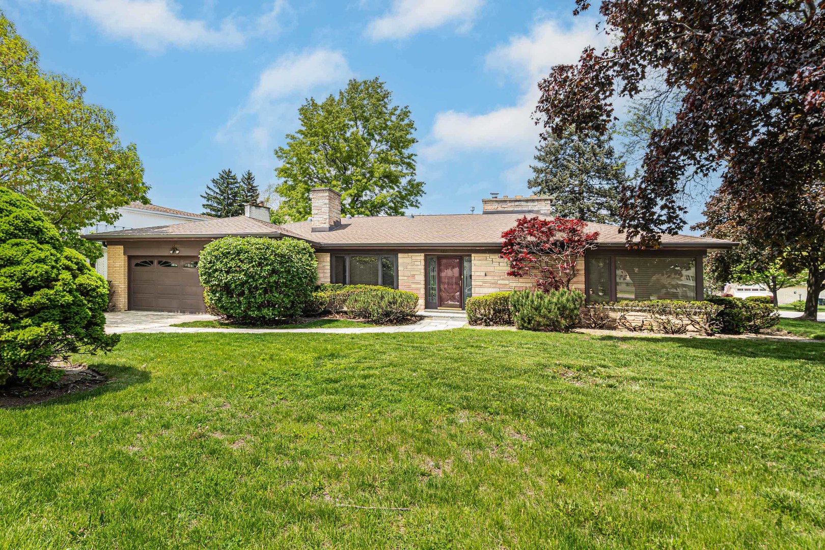 Welcome to this beautifully maintained, all-brick ranch situated on a spacious corner lot in the sought after Bunker Hill Estates subdivision. This home boasts an open floor plan and a huge gourmet kitchen featuring granite countertops, built-in refrigerator, double oven, cooktop with vent hood, skylights, and a large center island with breakfast bar-perfect for entertaining. Natural light floods the living room, dining room, and breakfast nook through expansive picturesque windows. Large living room features an all brick fireplace. The main level offers 3 generously sized bedrooms and 2 updated full bathrooms. Downstairs, you'll find a finished basement with a massive 45' x 26' rec room complete with a cozy fireplace, an additional bedroom, and a luxurious full bath featuring a steam shower and jacuzzi tub. Step outside to enjoy a lighted perennial garden and lush, mature landscaping with an automatic sprinkler system. A new roof and an oversized 2.5-car garage add to the home's value and appeal. Located in top-rated Niles School District, you're just 20 minutes from downtown and minutes from Bunker Hill Forest Preserve with access to the North Branch Trail System. Nearby attractions include Fernwood Botanical Garden, the iconic Leaning Tower of Niles, Golf Mill Shopping Center, as well as a variety of restaurants, coffee shops, and parks. Don't miss this opportunity to own a home in one of the area's most popular neighborhoods!