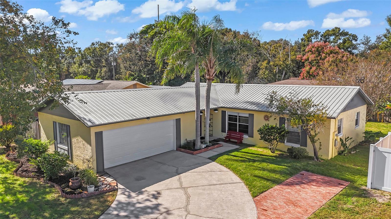 Looking for a beautiful home in Brandon? Look no further!  This charming 3-bedroom, 2-bath residence is sure to impress from the moment you arrive. The home offers outstanding curb appeal with tasteful exterior colors, metal roof, native Florida landscaping, and a curved driveway leading to a side-entry two-car, extended garage.  Inside, you’ll find gorgeous Saltillo tile flooring flowing through the main living areas, and crown molding throughout the entire home. The living room opens to the dining room, conveniently located just off the kitchen.  And oh, the kitchen! The cook in the family will appreciate the beautiful cabinetry with soft close drawers, pendant lighting, subway tiled walls, abundant counter space, porcelain farmhouse sink, LG refrigerator and range and Bosch dishwasher, and an oversized, walk-in pantry—perfect for storage and organization.  This home has been lovingly remodeled with attention to detail, including modern interior colors, updated bedroom carpeting, and sleek, stylish bathrooms.  Many of the windows are updated vinyl, double pane.  Step through the double pane French doors with blinds inside to your own tropical oasis. The fully fenced yard offers privacy and is ideal for relaxing, gardening, or entertaining friends and family.  There is a shed in the backyard that is perfect for storing your lawn equipment.  With NO HOA and NO CDD, you’ll enjoy freedom and flexibility.  Talk about location—this home is close to the Brandon Exchange shopping mall, as well as a wide variety of shops, restaurants, entertainment, Brandon Hospital, and medical facilities. Commuters will love the easy access to Hwy 60, I-75, Hwy 301, and the Crosstown Expressway, providing quick routes to downtown Tampa, MacDill AFB, and Tampa International Airport.  Don’t miss out—schedule your appointment today to see this lovely home!