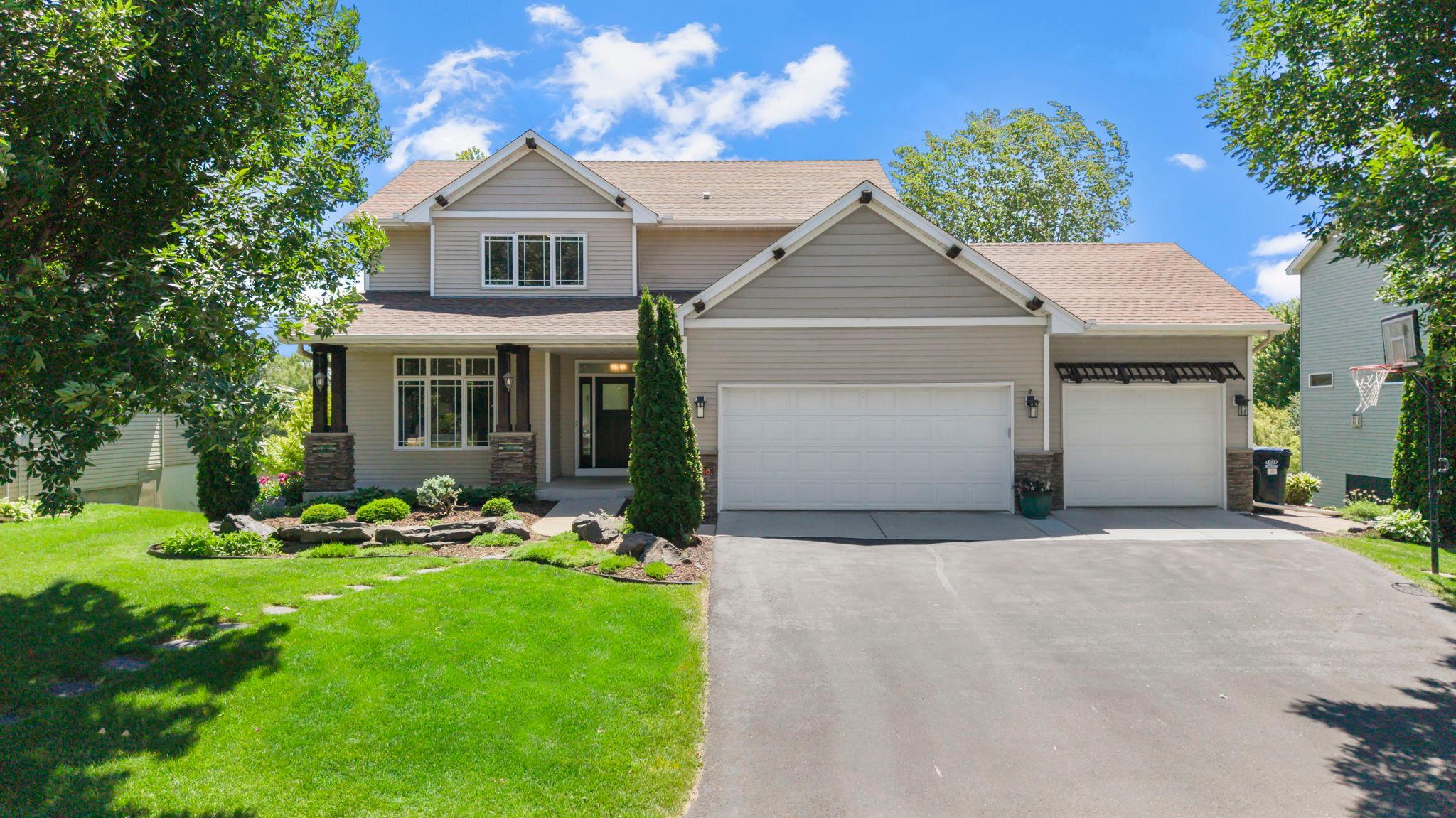 Welcome to this stunning 5 bedroom, 4 bathroom home in Farmington, known for top-rated schools, parks, trails, and an easy Twin Cities commute. Walkable to Lake Julia Park and  direct access to the North Creek Greenway system, just minutes from shopping and dining, the location is hard to beat.Inside, custom woodwork and premium hardwood floors set the tone throughout. The main level features a front office with built-in cabinetry, a sun-filled living room with floor-to-ceiling windows, and a dining room with deck access. The kitchen offers stainless steel appliances (2023), ample cabinetry, and a large center island. The mudroom/laundry area includes a Samsung washer and dryer, utility sink, built-in storage, and access to the fully insulated 3-car garage with a finished flex space and loft storage.Upstairs, the primary suite features 10' vaulted ceilings, a walk-in closet, and a full ensuite with soaking tub, walk-in shower, and pond views. Three additional bedrooms and a full bath complete the upper level.The finished lower level is an entertainer's dream with a walkout family room, wet bar, beverage fridge, and a fifth bedroom with a Murphy bed. A ¾ bath with walk-in tile shower, storage room, and roughed-in sauna space and radiant in-floor heating round it out.Outside, the custom deck features integrated planters, high-top seating, a future outdoor kitchen area, and sweeping pond views, all surrounded by professional landscaping and a full irrigation system.
