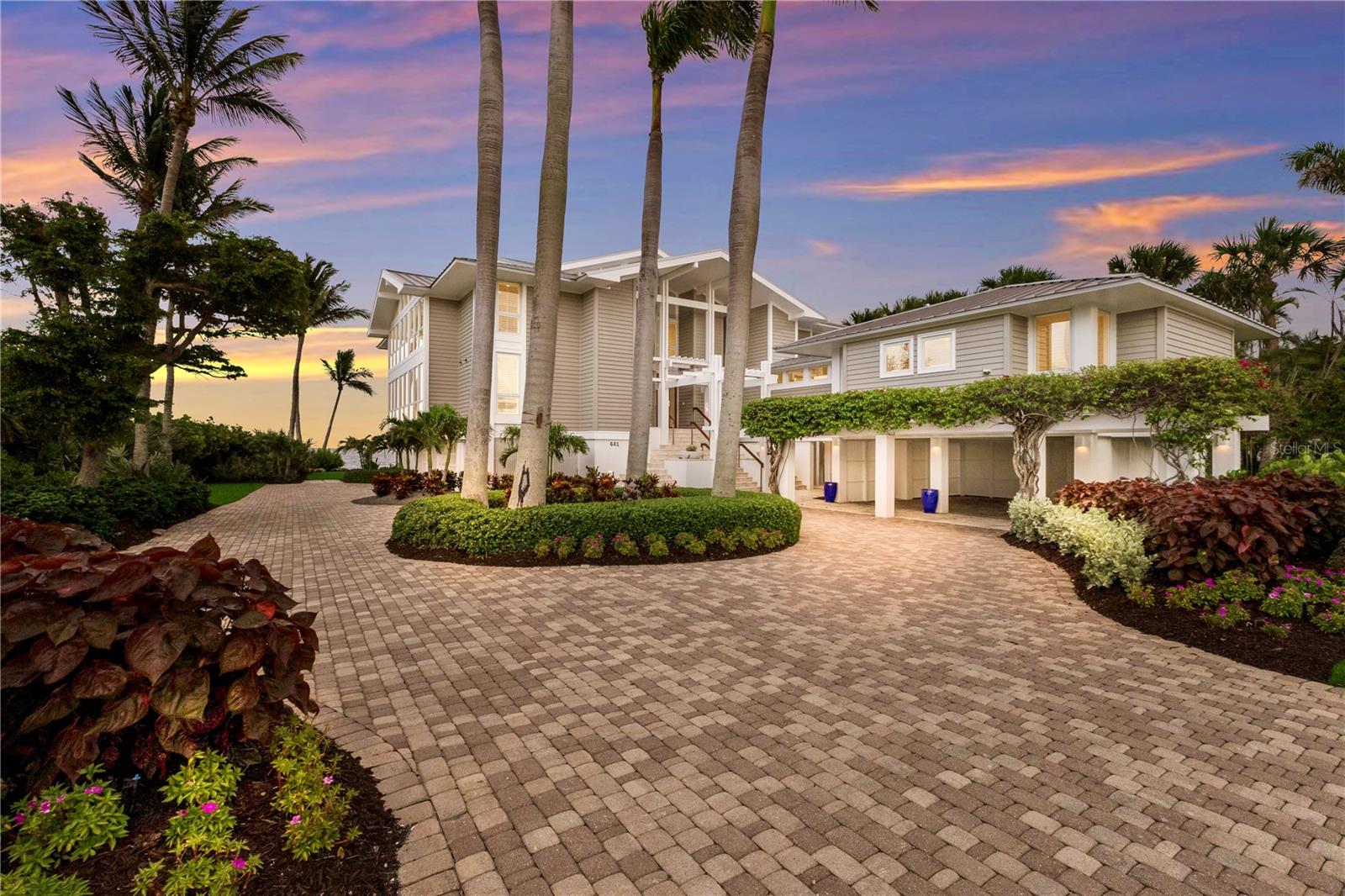 Welcome to one of Boca Bay’s most extraordinary residences—an architecturally stunning home in the exclusive, gated enclave of Grande Bay. Designed by acclaimed Sarasota firm, Seibert Architects, to capture the expansive views of Charlotte Harbor and the natural environment, it is perfectly positioned on the neighborhood’s most private homesite - the only site without a neighboring home to the North, being directly bordered by Boca Bay preservation land.Spanning 4,982 square feet, this one-of-a-kind residence is a masterclass in light, space, and elegance. Towering ceiling volumes on the main level create a grand, airy ambiance, while floor-to-ceiling windows along the entire North side frame uninterrupted vistas of Charlotte Harbor and Boca Grande’s bayside coastline. Internal spaces are organized around the central volume flowing freely from area to area.  Nearly every room enjoys a water view, and the top living level offers a rare, sweeping panorama that stretches from the radiant sunrises of Charlotte Harbor to breathtaking sunsets over the Gulf to the west. French doors along the waterfront façade blur the boundary between indoors and out, drawing in the beauty of the harbor at every turn.A private deep-water dock extends into the harbor, offering an exceptional vantage point to take in wide-open bay views and direct access to boating, fishing, and waterborne adventures right from your backyard.The reimagined chef’s kitchen is both functional and sophisticated, outfitted with Sub-Zero refrigeration, Wolf double ovens, a Viking induction cooktop, and a custom-designed coffee bar, all set against bespoke cabinetry and refined finishes.Every detail reflects craftsmanship and intention: level 5 smooth-finish walls, impact-rated windows and doors, a Control4 whole-home automation system with integrated LED scene lighting, a private elevator servicing all three levels, and hurricane-rated roll-down Magnatrack screens. A powerful whole home Kohler generator ensures uninterrupted comfort and security.As part of Boca Bay, residents enjoy access to resort-style amenities including four pools, the newly renovated Pass Club, a private beach club, a bayside fishing pier, a fitness center, Har-Tru tennis courts, pickleball courts, and a vibrant social calendar.  Impeccably maintained and thoughtfully updated throughout, this exceptional Grande Bay estate is a rare offering—an exquisite blend of privacy, design, and waterfront splendor in one of Boca Grande’s most coveted communities.