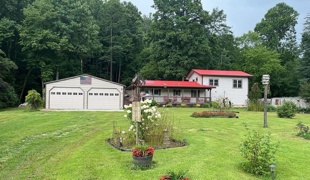 Creekside!!!!! this gorgeous three bedroom ,two bath on two lots. Own both side sides of the creek. wonderful front porch and screen back porch overlooking the creek and a basement workshop. The property has a spacious detached two car garage, bonus room, spa room. The living room is entered from the foyer and a beautiful fireplace with gas logs and built-in bookshelves await you. The kitchen has granite countertops, including all new appliances. The master bath has a walk-in shower and a beautiful laundry room a new roof was added to the home in 2023. The detached garage is 28 x 28 and there's a bonus room that's used as a bedroom and living area behind it that's 28 x 16. The spa room has a six person spot and more living space. 2 1/2 acres on the home with another piece of property on the other side of the creek makes it 3.53! You must see this home to appreciate all of the garden, landscaping, flowers, and plants. The front yard is used for hay twice a year and you could probably add one more home if you want.