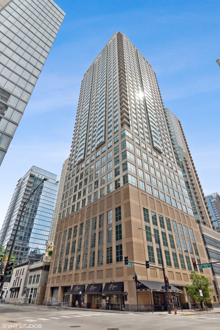 An exceptional opportunity in the heart of River North-just steps from Michigan Avenue. Everything one desires in their vibrant downtown lifestyle. This fully renovated, sun-filled 3 bed, 3 full bath SOUTHWEST corner condo offers over 2,000SF of modern luxury. Two homes have been masterfully combined with luxury living in mind -- you will enjoy a smart, open-concept layout and floor-to-ceiling windows at every turn showcasing expansive city views. The energy is felt with jaw-dropping exposures reminding you why you live in the Windy City but also offering complete serenity above It all. The chef's kitchen is a showstopper with flat-panel cabinetry, oversized quartz island with breakfast bar, beverage center, stainless steel appliances, and designer tile backsplash. A spacious designated dining area and private covered corner balcony create the perfect setup for entertaining. Two expansive primary suites feature spa-inspired baths with dual vanities, truly oversized showers, and custom storage. All bedrooms accommodate queen/king beds, and the enclosed home office nook adds ideal flexibility with a closet, as well. Wide-plank grey oak flooring, abundant closet space, in-unit laundry, and a second beverage fridge elevate the everyday. TWO storage units come with the home. Located in a full-service building with sundeck, fitness center, and hospitality room-all in a prime, walkable location near world-class dining, shopping, parks, the lake, and transit. One attached garage spot included in the price. Additional spot available.