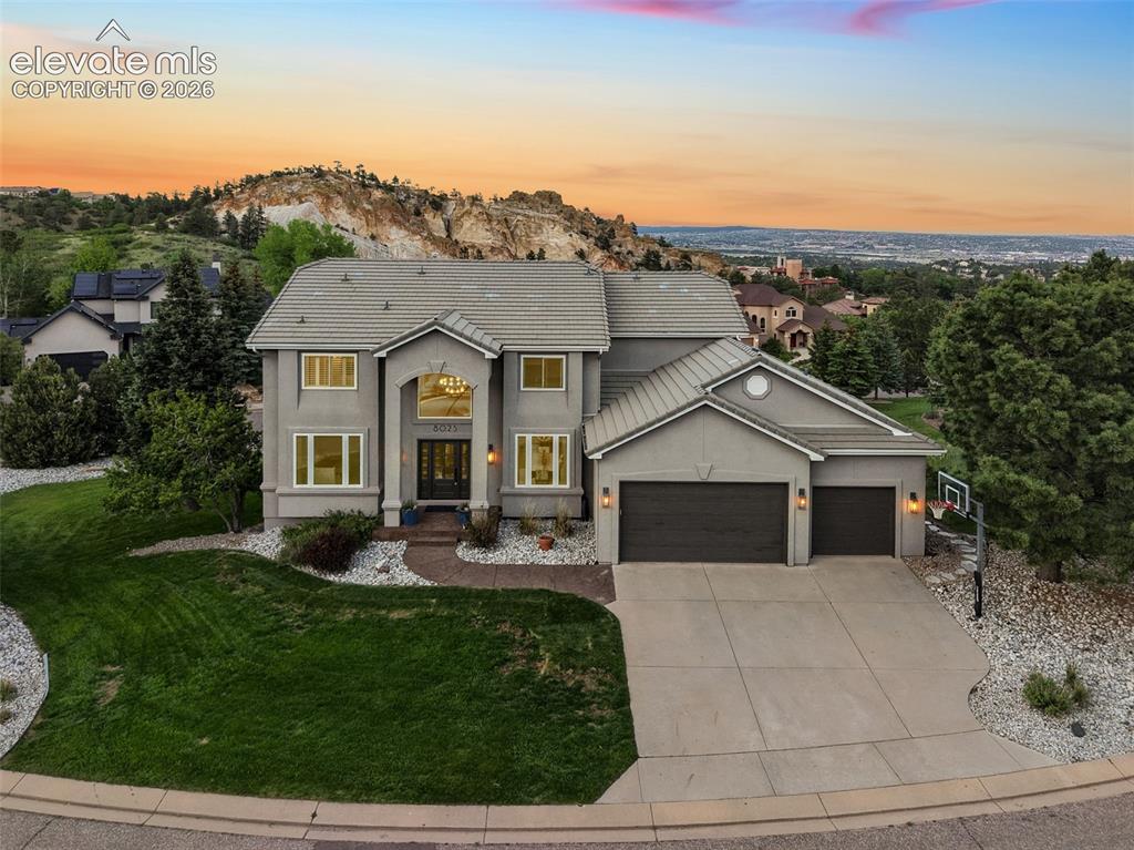 Nestled on a quiet cul-de-sac in highly sought-after Peregrine, this exceptional luxury residence offers a rare combination of breathtaking views, designer finishes, & an unparalleled setting on a flat, usable half-acre lot. Perfectly positioned to capture sweeping vistas of Blodgett Peak, the iconic Hoodoos, & the sparkling city lights below, nearly every window frames a stunning Colorado backdrop.Thoughtfully updated throughout with designer-quality finishes, this two-story home showcases white oak engineered hardwood flooring across the main level & all bathrooms, creating a seamless blend of elegance & warmth. The gourmet kitchen serves as the heart of the home, featuring high-end finishes, premium appliances & impeccable attention to detail, while the adjoining spaces are ideal for both everyday living & entertaining. A formal dining room with porcelain tile provides the perfect setting for memorable gatherings, & the main-level office offers flexibility as a guest bedroom or private workspace.Retreat to the luxurious primary suite, where a cozy gas fireplace creates a private sanctuary. The adjoining five-piece spa-inspired bathroom has been beautifully remodeled with designer selections & premium finishes, delivering a true luxury experience. Step outside to enjoy Colorado living at its finest on the expansive composite deck overlooking the large, flat, beautifully maintained yard—an increasingly rare feature in this premier location. Whether hosting guests, enjoying morning coffee, or taking in spectacular sunsets over Blodgett Peak, the outdoor spaces are as impressive as the home itself.With a tile roof, exceptional curb appeal, award-winning Academy District 20 schools, & close proximity to the Blodgett Peak Trailhead, shopping, dining & everyday conveniences, this remarkable Peregrine property offers the perfect blend of luxury, lifestyle, & location. A truly rare opportunity to own one of Colorado Springs’ most desirable view properties.