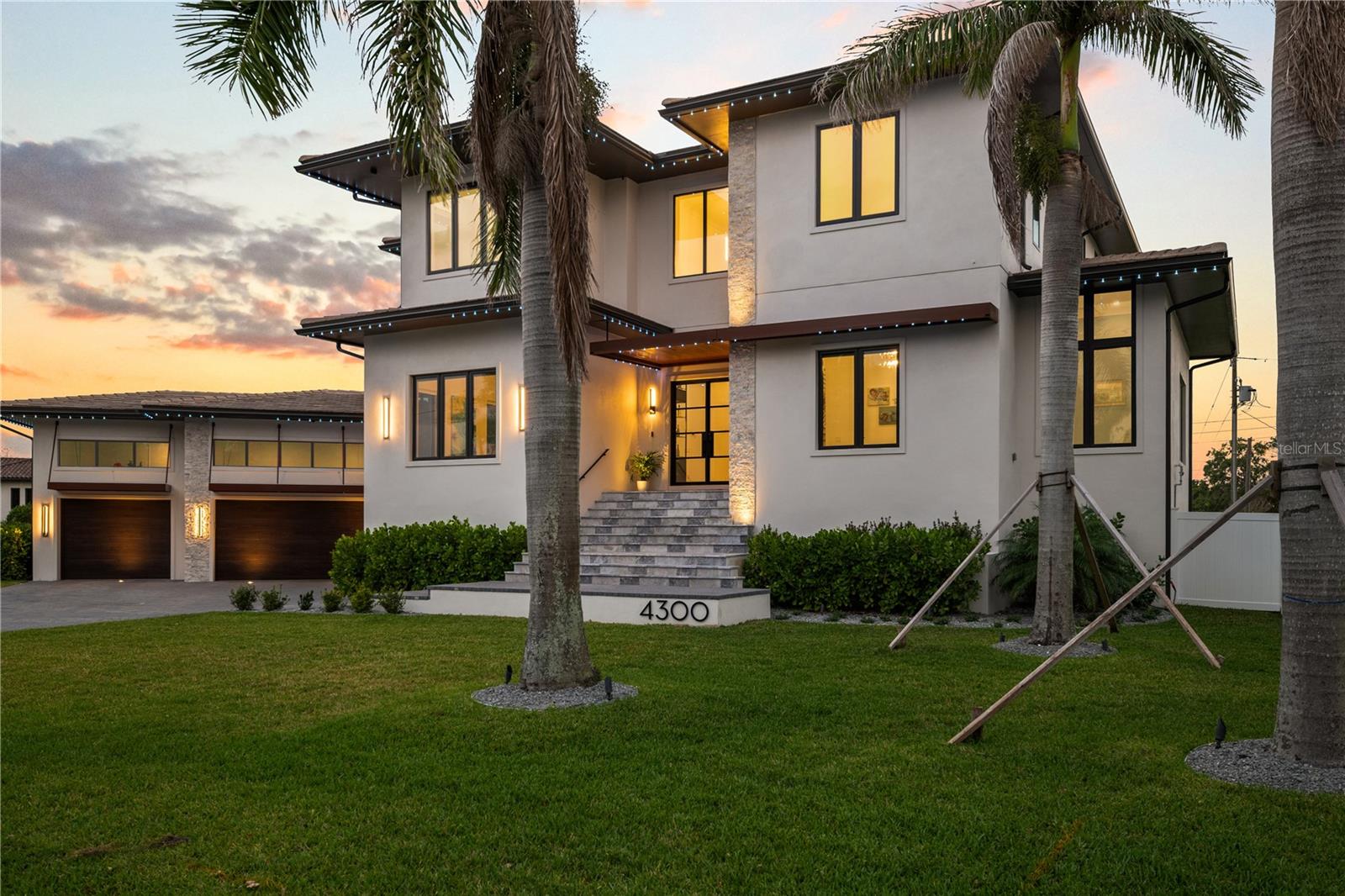 Experience a one-of-a-kind residence on an exceptionally rare lot. 4300 Bayshore?Blvd?NE is a masterclass of intentional design, exacting standards, and elegant finishes. At 5,795 heated square feet (7,410?sq?ft total) with six bedrooms, 6.5 baths, an oversized game room, dedicated front office, piano room off the foyer, butler’s pantry, and two dedicated laundry rooms, and a 3 car garage, this home has all the space you could need with refined beauty around every corner. The brief for this custom residence was focused on crafting a warm, welcoming space—one that blends tradition with a refined modern sensibility. From the moment you step through the custom metal doors, you’re met with a sense of calm. A textural timber feature wall draws the eye inward, leading to a handcrafted staircase with sculptural presence. To your left is the dedicated dining room that is emphasized with the art-inspired wine display. As you head towards the kitchen, on your right is the 23’8” x 15’8” bonus game room with 12ft soaring ceilings that serves as a movie theater, kids room, golf simulator, or the private gym you’ve always wanted! Designed with entertaining and everyday family life in mind, the heart of the home unfolds in an open-plan living area anchored by a dramatic built-in fireplace, sprawling chef’s kitchen, and overflowing natural light. The kitchen was conceived through a thoughtful collaboration with a renowned Hamptons designer, showcasing a Thermador appliance package with built-in coffee maker and double wall oven, and a custom island with waterfall edge, seating, and oversized sink. A butler’s pantry offers an apron-front sink, full-size refrigerator, wine fridge, walk-in pantry, and steel-rolled wine and champagne cabinet. Outside, the pool area is your own private resort: mature royal palms, heated saltwater pool with a hand-troweled mini pebble finish, premium wood-look porcelain pavers, and an outdoor shower set the scene for leisure. The greenspace beyond the expansive pool deck is big enough to host a soccer match, build a tennis court, or do some pitch-and-putt right in your backyard! In your covered lanai, a built-in Artisan kitchen lies under tongue-and-groove wood ceilings and is surrounded by tiered planters. Heading upstairs, the master suite is a true retreat. Serene water views and a dedicated lounging area for morning coffee will have you not wanting to leave it. It’s en-suite bath draws inspiration from luxurious European spas and is defined by porcelain timber-look cladding and deep, moody tiles. The palette and materiality create an atmosphere that is both grounding and indulgent. The dual shower and rainfall heads, niche LED lighting, and floating cabinetry elevate the class of the space. Walk right into your dream closet with plenty of room for two, including a custom island and a built-in LG clothes steamer unit. Your own dedicated upstairs laundry room with private access from your master suite features pull-out drying racks to make chores effortless. ALL bedrooms feature en-suite baths with custom vanities, quartz countertops, and floor-to-ceiling tile. The first floor guest suite is perfect for the in-laws and has the second laundry room near the garage. Throughout the home, tactile finishes, an earthy palette, and intentional design elements and contrasts around each corner elevate daily living into an art form. Unlock the dream Florida lifestyle with 4300 Bayshore Blvd NE — book your private showing today!