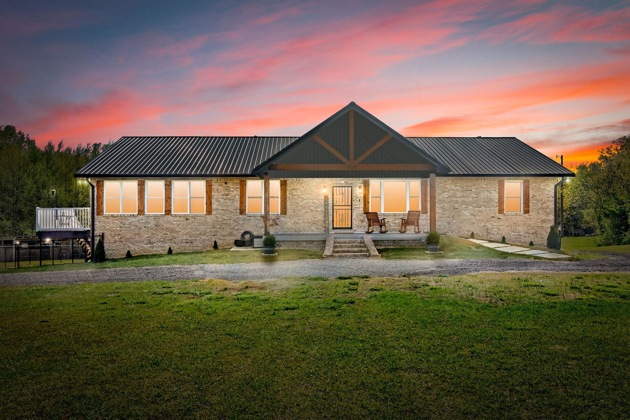 Breathtaking 9-Acre Homestead - Peaceful Country Living - All Close to Town! Welcome to your dream country retreat, where rolling pastures meet wide-open skies. This beautifully crafted home come's together in perfect harmony with 9 pristine and usable acres with your very own pond, all in the highly sought-after location of Sango. This one-of-a-kind property offers the best of both worlds, peaceful rural living close to downtown Clarksville and 40 minutes to Fort Campbell and Nashville. Fenced pasture ready for horses, cattle, or your own little farmstead. 24x40 foot greenhouse with garden beds already in place and ready for your favorite produce. 24x30 foot pole barn for storing boat, RV, tractor etc. Chicken, and bunny coop with space to expand. Enjoy the peace of mind you will get knowing you're in a well-built all brick home with superior basement walls, reinforced storm shelter, with generator wired to run basement and refrigerator. New roof 2023, New hot water heater 2022, gas range, upgrades throughout, STUNNING sunroom, two decks, covered front porch, 4 car garage, finished basement with room for guests or in-law suite with full bathroom and more! Do not miss the opportunity to have your own move in ready homestead! The cherry on top is the possibility of a loan assumption with a 2.75% interest rate! Call today to make it yours! Check out the video at the bottom of this page!