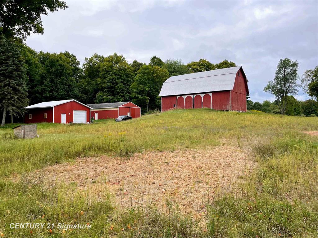 Title work has been cleared up and property is now ready to be sold. Unique piece of higher land with lots of potential! Could be the perfect start to a HOMESTEAD. The rolling hills with mature trees could be perfect location for starting a DEVELOPMENT. Or run your SMALL BUESINESS out of the insulated out-buildings. So many possibilities here. The larger of the two insulated pole barns has running water from the NEW WELL. The hay/livestock barn is in great shape for its age. There are several acres that could be tillable. Approx. barn sizes:  #1 - 30x40; #2 - 30x60; #3 - 30x55. Feel free to reach out with any questions. Vestaburg School district.