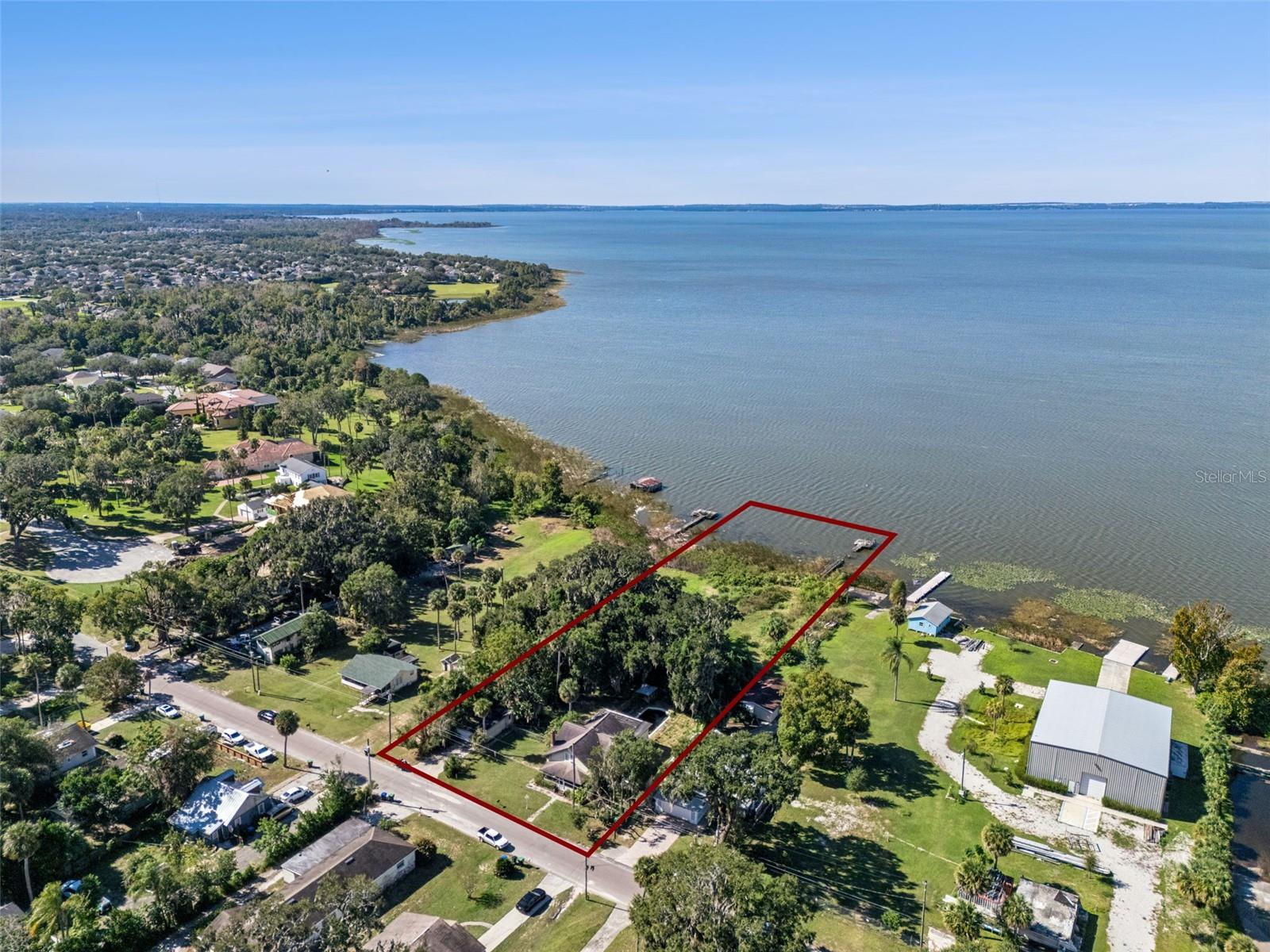 C2 Zoning + Residential | Price Adjustment | Rare Lakefront Opportunity on Lake ApopkaPrice adjustment reflects seller motivation and creates an outstanding opportunity to acquire a rare lakefront property on Lake Apopka with C2 commercial zoning and residential use. This unique combination allows for a wide range of potential uses, making it ideal for investors, owner-operators, or buyers with a long-term vision.The property features a classic lakefront home with strong character, including an updated kitchen with a large center island, three ovens, ample storage, and real wood flooring. A walk-out basement adds flexibility, while the main level includes one bedroom and one full bathroom. The second floor offers three additional bedrooms.A central HVAC system is installed but not currently operational; the home is currently cooled with window units. The shingle roof was replaced in 2016, while the flat roof will likely need replacement. Electrical and plumbing updates will be needed, presenting a clear value-add opportunity for the right buyer.Additional improvements include an enclosed carport/garage, chicken-breeding coops, and a private dock, enhancing both lifestyle appeal and future development potential.