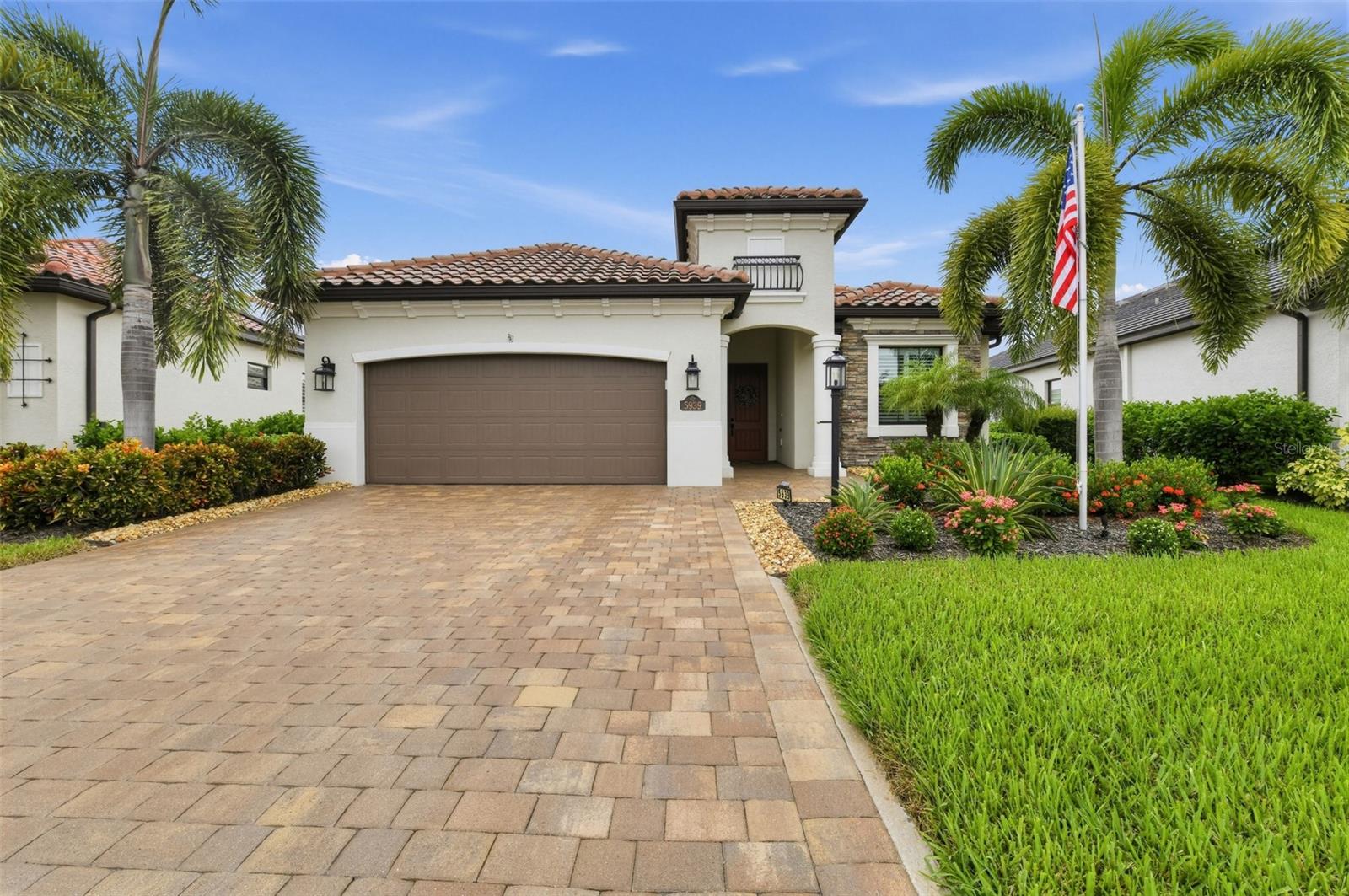 **Exquisite 3-Bedroom Home plus flex room with Golf Course & Lake Views in Lakewood National Golf Club** Welcome to Lakewood National Golf Club, an exclusive, gated community in Lakewood Ranch offering resort-style amenities and world-class living. This stunning home sits on a premium lot with breathtaking views of #1 Piper Golf Course and its serene adjoining lake. Experience picturesque sunrises and the tranquility of nature right from your own backyard.  Three spacious, well-appointed bedrooms complemented by a versatile flex room perfect for a home office or den. Both bathrooms are designed with Cambria countertops and premium finishes to deliver luxury and functionality. The great room features a beautiful, modern stacked stone electric fireplace, creating an inviting atmosphere for relaxing evenings or entertaining guests. Durable, low-maintenance LVP flooring throughout the entire home provides a seamless and sophisticated appearance. A redesigned gourmet kitchen featuring elegant Cambria countertops and backsplash, a larger pantry for effortless organization, and a custom linear island for extra prep space or casual dining.  Built-in Bar with Wine Refrigerator to entertain guests in your great room that combines function and luxury for hosting friends and family. Take advantage of Florida's incredible weather on your personal extended lanai that features LED lights integrated into the cross beams for evening ambiance.  Lanai includes outdoor kitchen complete with a grill, refrigerator, and ample food prep space. Enjoy unobstructed views from the hot tub through the panoramic view screen on the lanai—a perfect blend of indoor and outdoor living. For extra peace of mind, the lanai is equipped with a hurricane shutter. 20K Kohler Whole House Generator provides reliable power backup that ensures uninterrupted living, no matter the weather. Relax knowing your home is equipped with a Pelican system delivering purified water throughout and recirculating Water Pump System for instant hot water at every faucet.  Driveway has been widened by 3 Feet for enhanced parking. Prestigious Community Amenities include two championship Arnold Palmer-designed golf courses, resort-style pool with waterfalls, lap lanes, and a relaxing hot tub, state-of-the-art fitness center with personal training, fitness classes and training equipment, Har-Tru tennis courts, pickleball courts, and bocce ball facilities, full-service spa for relaxation and rejuvenation and fine dining and social events at the stunning clubhouse. Indulge in resort living and breathtaking views every day—your dream home on #1 Piper Golf Course awaits!