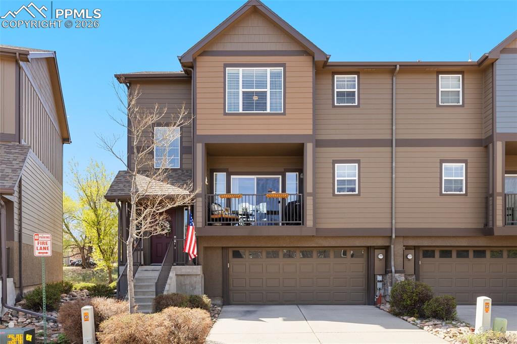 Welcome to Creekview Townhomes, a gated community offering low-maintenance living in an exceptional Northwest location. This immaculately maintained end-unit home backs to open space and showcases beautiful Pikes Peak views, creating a rare combination of privacy, scenery, and convenience. Filled with natural light from expansive windows on multiple sides, the main level features an open and inviting layout designed for both everyday living and entertaining. The spacious living room centers around a cozy gas fireplace and flows seamlessly into the dining area with walkout access to a covered patio—perfect for enjoying peaceful mornings and Colorado sunsets. The kitchen offers ample cabinetry, generous counter space, and easy connection to the main living areas. Upstairs, you’ll find three comfortable bedrooms, including a spacious primary suite with a walk-in closet and en-suite bath, along with two additional bedrooms and a full bathroom. A conveniently located upper-level laundry area adds everyday ease. Perfectly positioned on a quiet interior street, this home offers direct access to the Sinton Trail for walking, running, or biking. Enjoy being just minutes from everyday essentials including shopping, dining, parks, and medical facilities, all while tucked into a serene, well-maintained community. With its pristine condition, open space setting, and stunning mountain views, this home offers an exceptional opportunity to enjoy the best of Colorado living. Schedule your showing today and experience it for yourself!