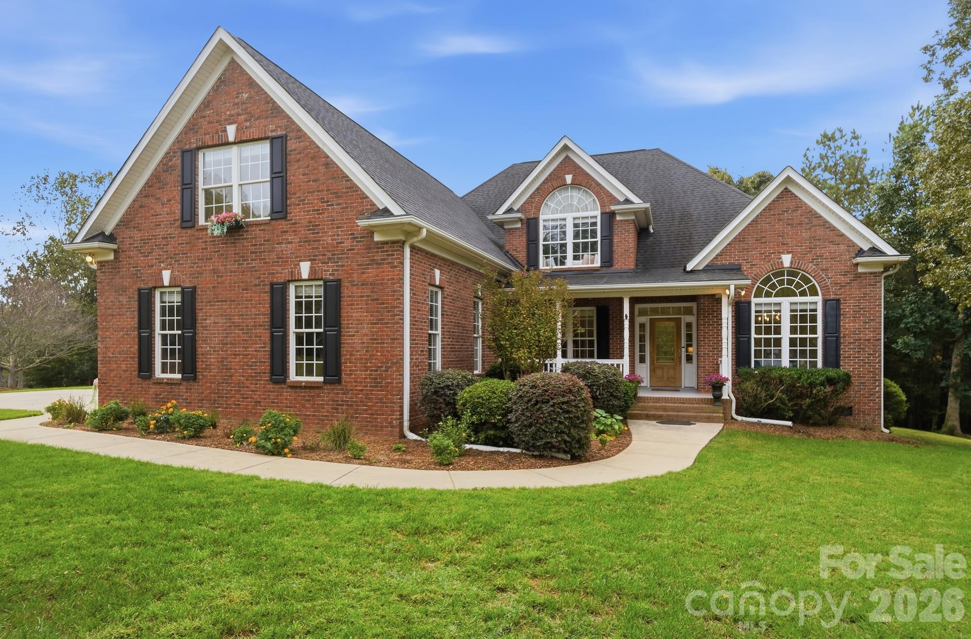 Hitch up the boat and move right in! This exceptional full-brick residence offers the rare combination of refined architectural detail, generous living spaces, and the freedom to truly enjoy the outdoors with the Lake Wylie lifestyle you’ve been waiting for. Set on 1.07 private acres in one of Lake Wylie’s most sought-after neighborhoods, this 4-bedroom home with an expansive 3-car garage delivers space, privacy, and room to make it your own.From the moment you arrive, the home’s classic full-brick exterior, and impressive scale set the tone. Discover solid hardwood floors, brand-new carpet, gorgeous moldings, and distinctive architectural details create an elevated yet welcoming atmosphere. Designed for both everyday living and unforgettable entertaining, the main level offers an exceptional sense of space and flow. The thoughtfully designed floor plan offers a room for every need, including a dedicated office, elegant dining room with soaring vaulted ceiling provides a sophisticated setting for special occasions, while the inviting breakfast room offers a more casual place to enjoy your morning coffee while taking in peaceful views of the outdoors.The spacious main-level primary suite is a private retreat, featuring a double-tray ceiling and a spa-like ensuite complete with a custom glass shower and freestanding soaking tub. And there’s no need to compromise on storage—the custom closet system provides exceptional organization and ample space.At the heart of the home, the kitchen is made for gathering, with abundant cabinetry, exceptional storage, and generous counter space that makes entertaining feel effortless. Whether hosting a crowd or enjoying a quiet morning, this home offers the space and functionality to accommodate it all. Just beyond, the stunning two-story great room makes a statement with its dramatic architectural details and inviting gas-log fireplace—the perfect place to gather, relax, and unwind. Upstairs, three generously sized bedrooms provide plenty of room for, guests, hobbies, home gym, or an entertainment room.Step outside and discover what may become your favorite room of all. The expansive covered and screened porch overlooks the private, natural setting, where peaceful views and visiting wildlife create a sense of escape rarely found this close to everyday conveniences. Imagine lingering over morning coffee, hosting summer dinners, or unwinding with glass of wine at sunset as the day fades away.And the possibilities continue. With over an acre of private land, there is plenty of room to create your own outdoor oasis—including the potential for a private pool.and settle into something increasingly rare: a home offering space, privacy, timeless quality, and the unmistakable feeling of Lake Wylie living at its best. This is more than a home—it’s a lifestyle waiting to be lived. You truly must experience this home in person. Come see why properties of this caliber so rarely become available.