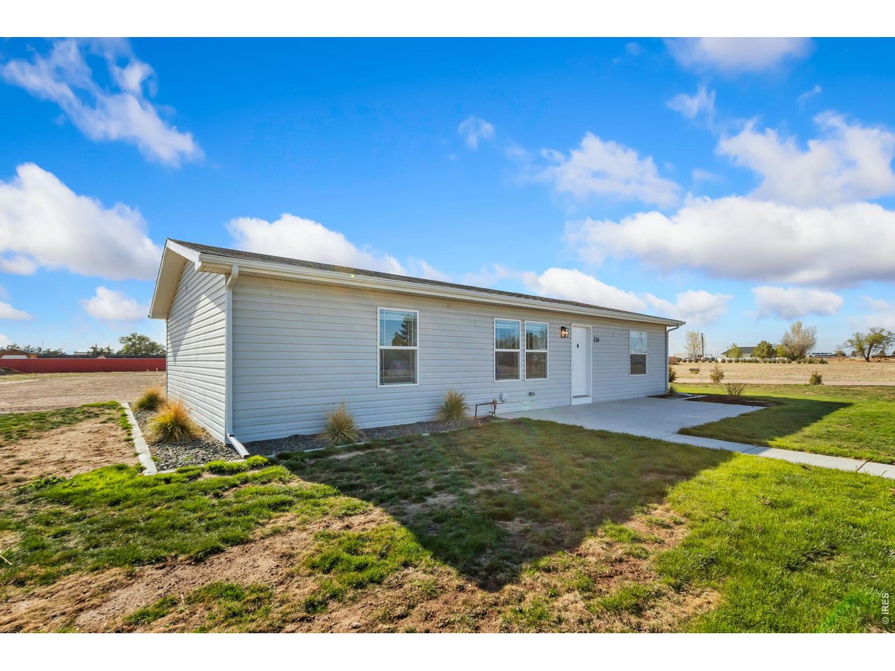 Wide-open living on nearly 5 acres just minutes from downtown. This single-level home sits on a spacious corner lot with ample opportunity to expand, build, or shape the property to fit your vision. Move-in ready with recent improvements that include fresh paint, new flooring, and updated trim, giving the home a clean, refreshed look that's ready to enjoy from day one. Step inside to a bright main living area that flows seamlessly into the kitchen and dining spaces, creating an easy, comfortable setting for daily living. The home features three bedrooms with a split-bedroom design that adds comfort and privacy, with the primary suite offering an ensuite bathroom and a walk-in closet. New concrete patios and curbing, along with a new sprinkler system elevate the property. The 30x40 insulated and heated shop provides a versatile space that can handle everything from projects to storage. With modern updates, functional outbuildings, and ample acreage just minutes from town, this property offers endless flexibility. No HOA! Possible potential to subdivide the property and build a 2nd residence or sell off a portion of the land.