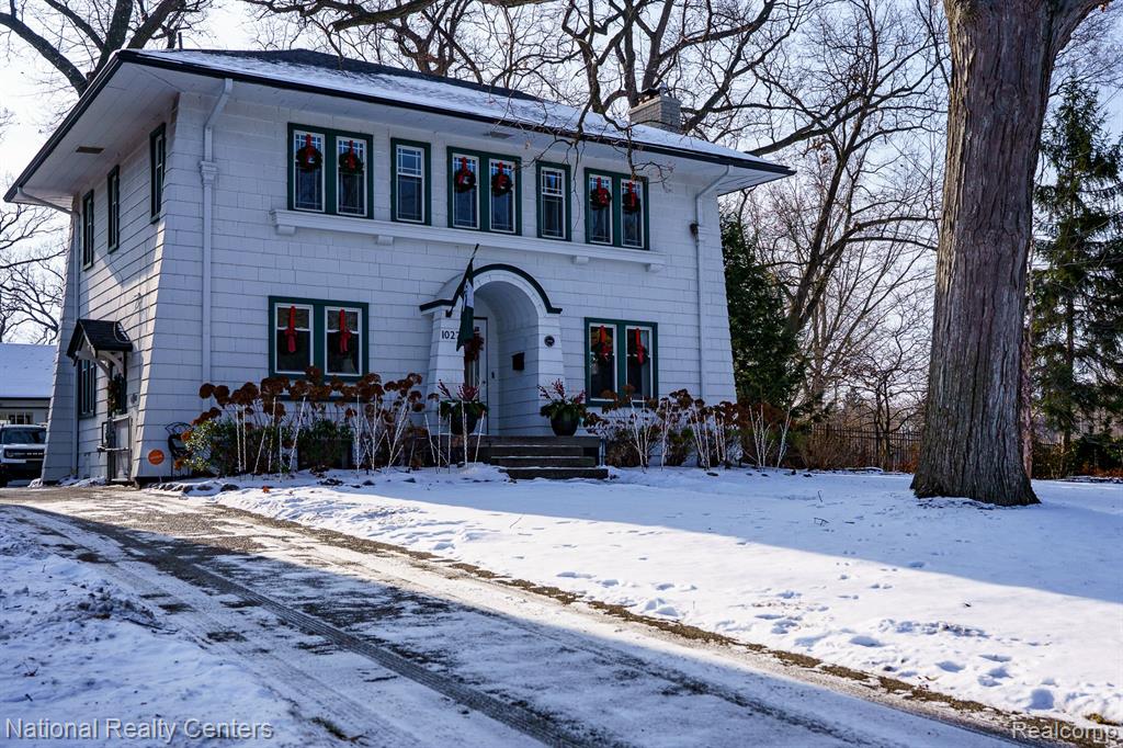 Welcome to 1027 West 11 Mile Rd, a stunning Prairie Style Craftsman home located in the Hendrie Blvd sub. This home has been exquisitely renovated with emphasis upon period detail. Upon your approach notice the newer exposed aggregate drive and walkway. The charming entry opens to the living and dining rooms, with arched doorways, original moldings and trim. The living room features beautiful hardwood floors, cove ceilings, a quintessential Prairie style brick fireplace with original bookend windows. The sitting room, open to the living room, overlooks the Trex deck and garden through the original French doors. The kitchen has been completely remodeled with quartz countertops, lighted cabinetry, apron sink, and high-end appliances all of which are included. Off the dining room is an alcove room perfect for a home office, library, or butler's pantry.  Upstairs you will find a light and bright primary bedroom with direct access to the full renovated bath and original built in closets and the attached summer porch, which has been converted to a dream custom walk-in closet. The ample second bedroom also features original built in storage and overlooks the stunning rear garden. The 2-car garage has a newer roof and automatic garage door as well as an attached workroom. A gate provides access to the rear alleyway.The extensive upgrades also include 42 windows, gas fireplace insert, new electrical wiring and panel with an outlet for a generator, water heater, A/C unit, new roof on house and garage as well as new gutters with leaf guards. Outside you'll find new composite privacy fence with an automatic gate, new landscaping and sprinkler system.This home is truly a must see, it's filled with the charm and warmth of yesteryear yet provides all of today's modern conveniences.