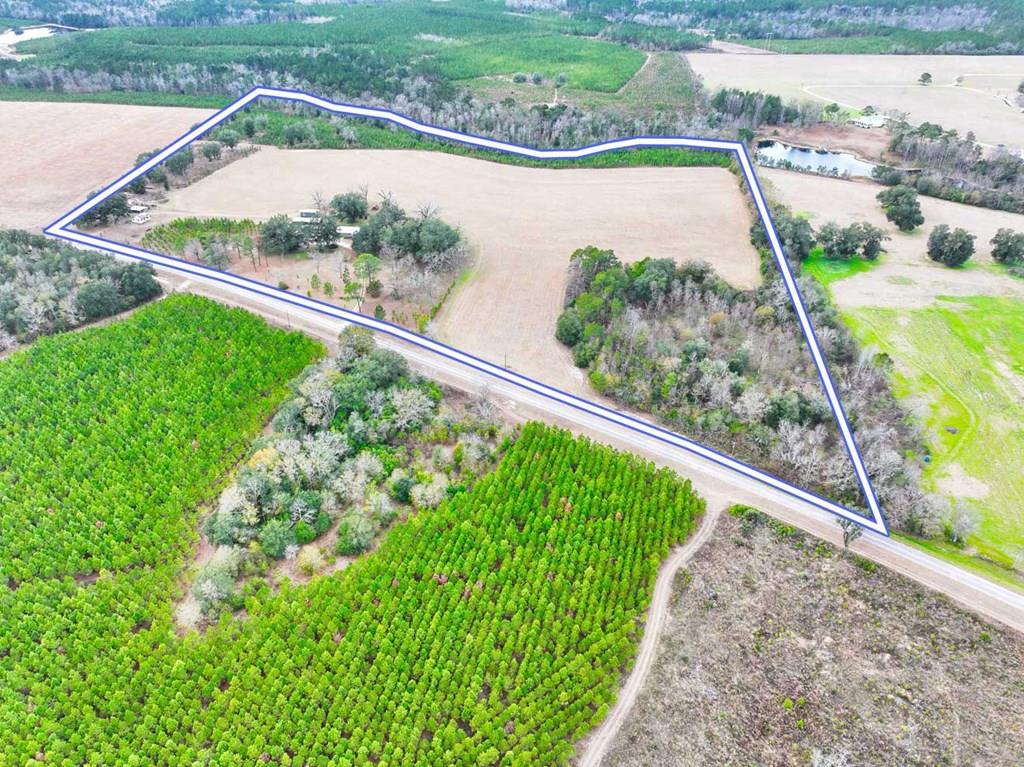 Ideally situated just 5 miles from Lake Seminole and Wingate's Landing, perfect for boating, fishing, and weekend adventures, and only 35 miles from Tallahassee for an easy commute or quick city getaway, this property offers the best of both worlds. From the moment you arrive, you're welcomed by over 47 acres of breathtaking oak trees, planted pine, and sweeping views that instantly make you slow down and stay awhile. Whether you envision planting, raising animals, or simply enjoying wide-open space, this property offers the perfect setting with incredible privacy.  Inside, the updated farmhouse features a bright, open layout designed for both comfort and entertaining. The kitchen is light and airy with stainless steel appliances and flows seamlessly into two separate living areas, providing flexible spaces for gatherings and everyday living.  The primary suite offers a peaceful retreat, complete with a spacious walk-in shower and a generous walk-in closet. The property includes an attached two-car garage for everyday use, along with an additional exterior bathroom ideal for rinsing off after a day outdoors. A four-bay detached carport provides ample room for tools, equipment, recreational vehicles, and additional covered RV parking, ensuring there is truly space for everything.  An additional historic home on the property presents outstanding potential for a guest house, studio, or income-producing rental. This is more than land. It's an opportunity to build, grow, and create lasting memories. Virtual 3-D Tour available upon request.