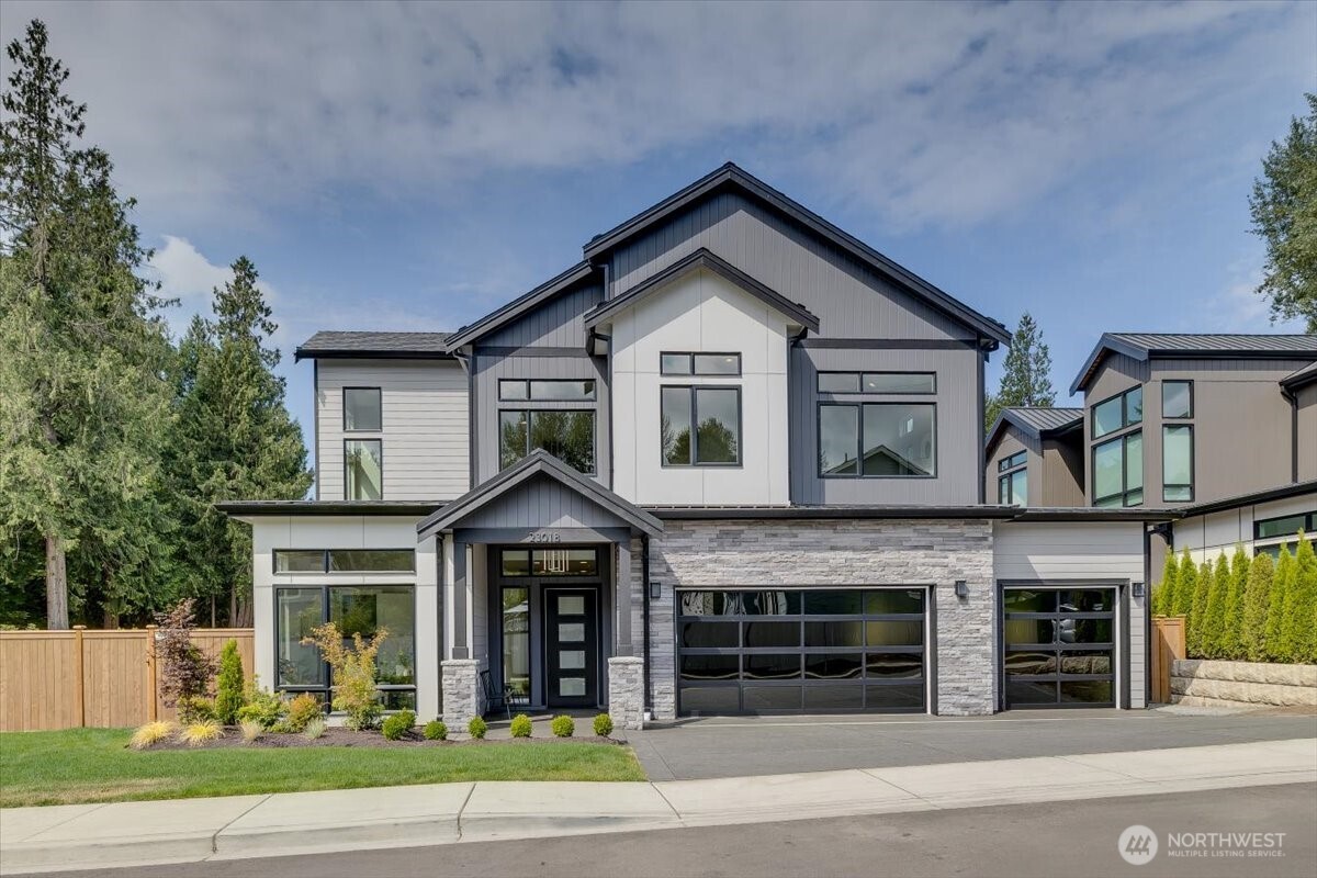 Stunning 5,700+ sq. ft. new construction, East facing luxury home in Bothell, located in the Northshore School District. Modern design with 5 bedrooms & 4 bathrooms, this exceptional residence pairs dramatic architectural details with sophisticated finishes. Featuring a true cook’s dream kitchen: waterfall island, abundant cabinetry, under-cabinet lighting, Wolf range, expansive walk-in pantry complete with its own sink, extensive cabinetry & second dishwasher. The open-concept design is enhanced by an elegant open staircase and expansive windows that fill the home with natural light.  The main level offers flexibility with a private guest suite and ¾ bath, dedicated den, media room, open great room with gas fireplace, dining room with wine storage, and convenient main-floor laundry. Upstairs, unwind in the luxurious and spacious primary suite featuring a beautifully appointed spa-inspired bath and an oversized walk-in closet with custom built-in cabinetry. A second laundry room upstairs adds another level of everyday convenience. Designed for relaxation and entertaining, the home also features a spacious game room with wet bar, generous secondary bedrooms including upstairs guest suite with 3/4 bath. Outside, enjoy the privacy of a fully fenced yard with covered outdoor patio and gas fireplace.  A generous three-car garage with electric car outlet provides ample room for vehicles & storage. This residence is an entertainers dream with luxurious touches throughout.