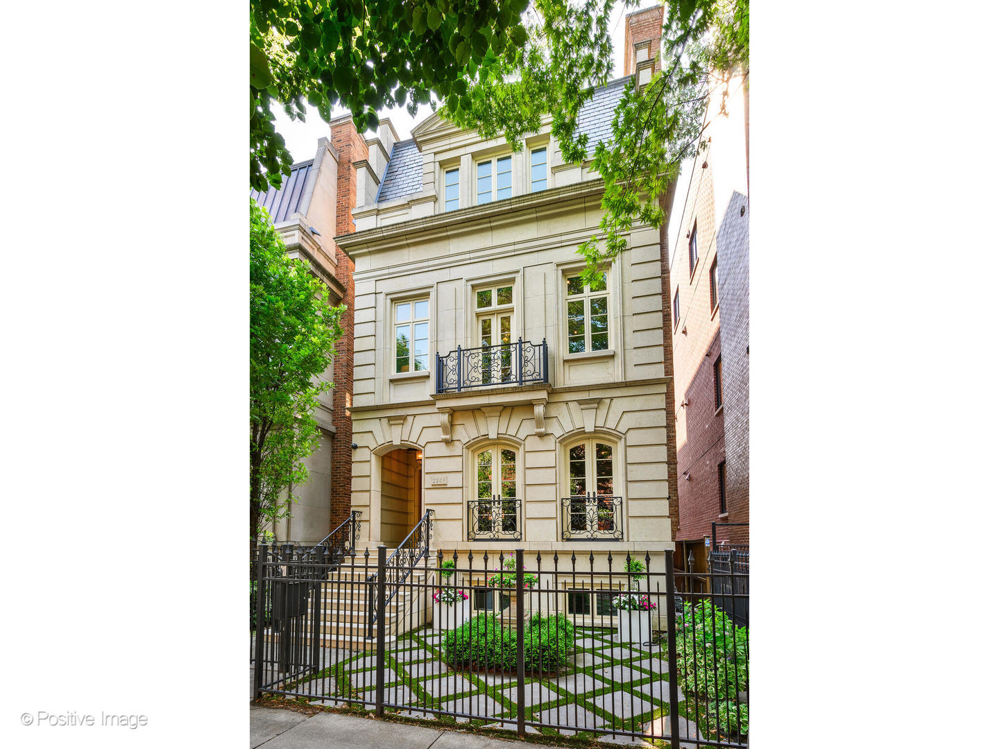 Introducing a rare opportunity to own a truly extraordinary single-family home in the heart of Lincoln Park, perfectly positioned just steps from Oz Park. Situated on an ultra-wide 31-foot lot, this magnificent 8,550 square foot, six-bedroom, five full and three half bath residence was masterfully crafted by award-winning GVP Development, known for their timeless design and superior construction. Spanning four thoughtfully designed levels, this home delivers uncompromising luxury and livability. A rich mahogany-paneled library sets the tone for elegance upon entry. The heart of the home-an expansive chef's kitchen and sunlit family room-opens seamlessly to a stunning two-tiered terrace complete with a wood-burning fireplace, creating a seamless flow for indoor-outdoor entertaining. A true rarity in the city, the attached heated 4-car garage offers unparalleled convenience. An elevator services all floors-including the penthouse level, where an incredible rooftop deck awaits with panoramic skyline views, ideal for sophisticated entertaining or peaceful retreat. Four bedrooms are located on one level, including a luxurious primary suite. Six of the bathrooms feature heated floors. The entire home is wired with an ELAN whole-house A/V system, elevating daily living with cutting-edge convenience. This is not just a home-it's a lifestyle, combining classic architecture, modern amenities, and premier location on one of Lincoln Park's most desirable streets.