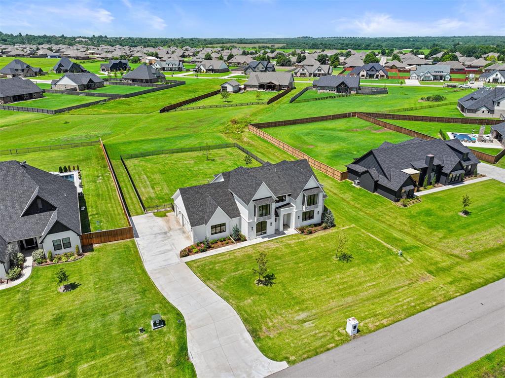 Welcome to this stunning modern home in the highly sought after Brentwood Addition in Norman, just off Hwy 9! Situated on a spacious 0.75-acre lot, this home offers an eye catching front elevation, wrought iron fencing, and a covered back patio perfect for enjoying unforgettable Oklahoma sunsets. From the moment you walk in you're greeted with sweeping views straight through to the expansive backyard. The open-concept layout is ideal for entertaining, featuring a breathtaking kitchen with a massive island, abundant cabinetry, gas appliances, and a walk-in pantry that will exceed your storage needs. The adjoining dining space overlooks the peaceful backyard, creating the perfect backdrop for everyday living and elegant entertaining. The living room is equally impressive, featuring 12-foot ceilings, a stunning floor-to-ceiling fireplace, and an abundance of natural light that fills the space with warmth and charm. The main floor includes 4 bedrooms (or 3 plus an office), 2.5 bathrooms, a mud bench, and a well-appointed laundry room. The first floor luxurious primary suite offers dual vanities, a walk-in shower, a freestanding tub, and a closet that dreams are made of. Upstairs you'll find a spacious versatile bonus room, an additional bedroom, and a full bathroom—perfect for guests, teens, or a private retreat. Pictures were taken before the new white oak floors were installed on the staircase and entire upstairs living areas.  This is the first resale home in the neighborhood and has only been lived in for 2 years, offering the feel of new construction without the wait. Every detail has been thoughtfully designed—this is one you don’t want to miss!