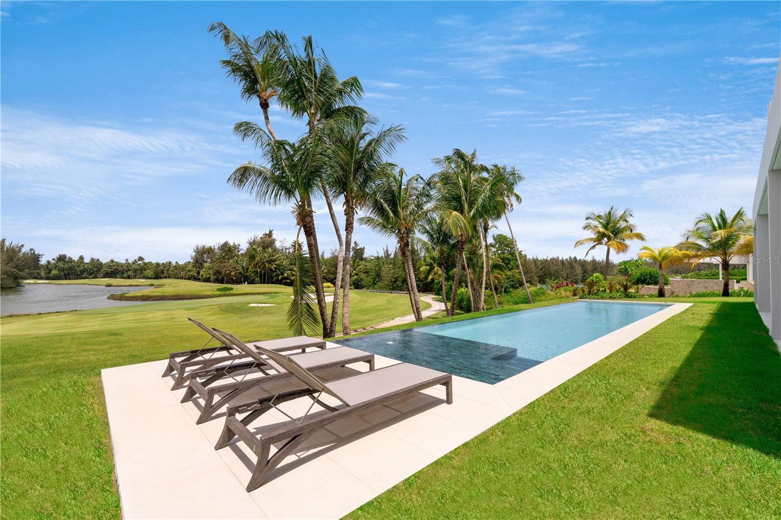 Paradise Perfected...Experience unparalled living & hospitality in Puerto Rico's premium residential address Bahia Beach Resort & Golf Club. Enjoy resort living in a brand new two-story modern home with spectacular views of golf, lakes and Bahia's natural sanctuary.