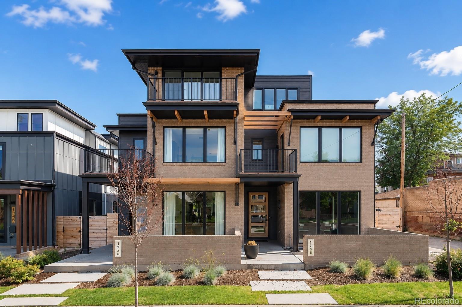 A rare urban sanctuary in the heart of Denver's coveted Sunnyside neighborhood, this contemporary duplex is perfectly positioned on a rare, expansive lot. A striking exterior and front patio set a sophisticated tone, while inside, high-end finishes, a statement fireplace and sliding glass doors to a covered private patio establish an effortless indoor-outdoor connection. The sleek kitchen impresses with a large center island, stainless steel appliances and generous cabinetry, while the dining area opens directly to the front patio via sliding glass doors. The primary suite is a true retreat, featuring a private balcony, a tranquil bath and a generous walk-in closet. A third-floor flex space with a wet bar and rooftop deck delivers sweeping city views, and a finished basement with soaring 10-foot ceilings provides additional living and recreation space. An oversized four-car detached garage, balconies across every level and a prime Sunnyside position complete this refined retreat.