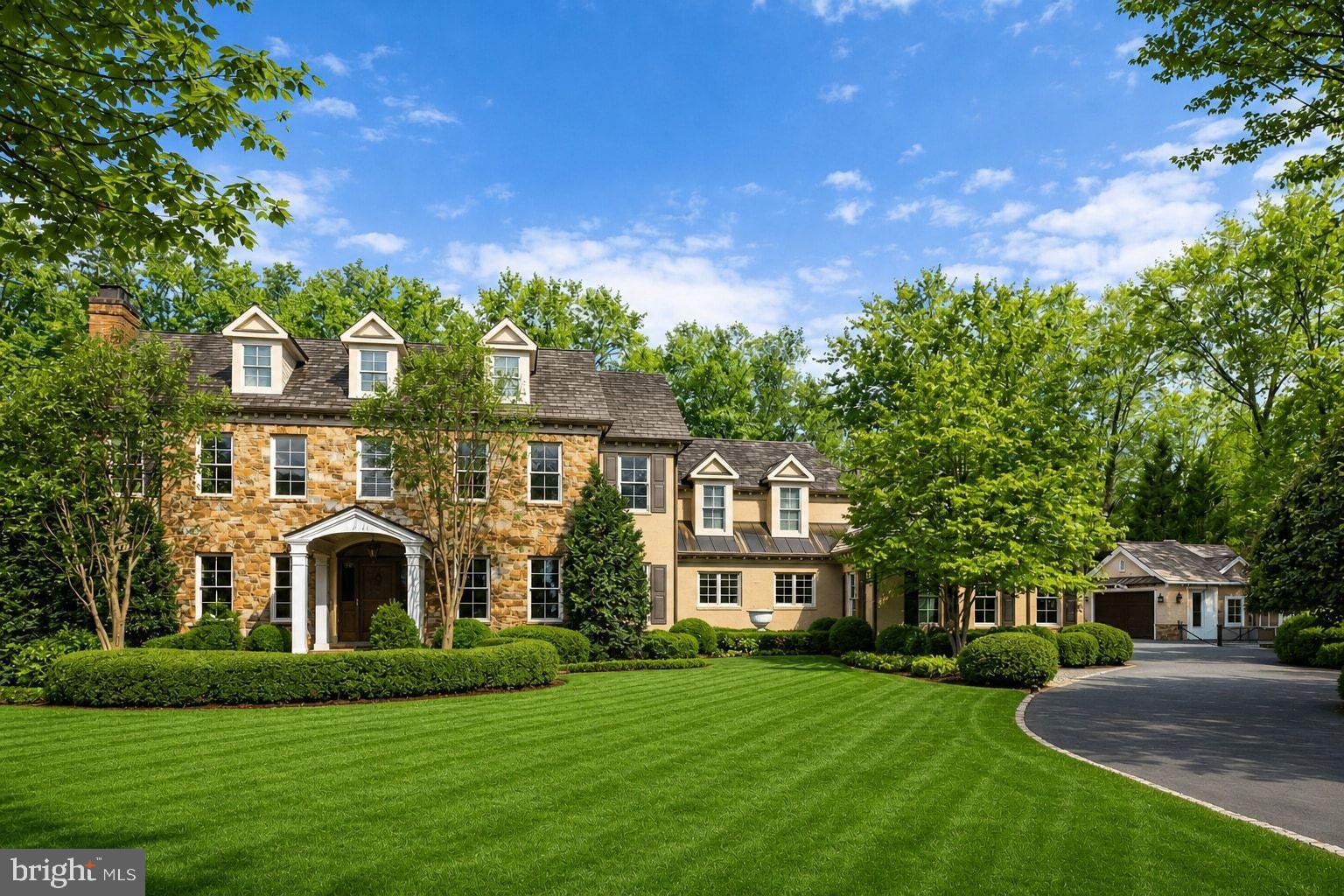 Privately positioned at the end of a quiet cul-de-sac on nearly two acres, this exceptional custom home by Artisan Builders offers timeless architecture, extraordinary craftsmanship, and a rare connection to nature. Backing to more than five acres of private historic preservation land, the property is surrounded by beautifully landscaped grounds, creating a serene and private retreat complete with a pool, gardens, fountains, patios, and mature trees. The elegant main level features an inviting foyer with custom wall coverings and art glass windows, a living room with coffered ceiling and marble fireplace, and a formal dining room featuring custom paneling and Italian plaster walls. The handsome library offers custom mahogany built-ins and paneling, while the chef’s kitchen is appointed with Lobkovitch cabinetry, top-of-the-line appliances, a walk-in pantry, and breakfast area. A comfortable den with surround sound, sunroom with heated floors, spacious mudroom, and two powder rooms complete the main level. The upper level features a luxurious owner's suite with a spa-inspired bath, Perrin & Rowe fixtures, and custom closets, along with three additional en-suite bedrooms, each with walk-in closets and separate heating and cooling zones. The lower level is designed for entertaining with a recreation room, fireplace, wet bar, fitness room, laundry, and generous storage. From the rear loggia, enjoy the spectacular grounds designed by Charles Owen Fine Landscaping, featuring elegant fountains, lush gardens, a fire pit, expansive lawn, and a charming Hartley Botanic English greenhouse with an irrigated vegetable garden. Offering exceptional privacy while remaining minutes from River Bend Country Club, Great Falls Village, parks, public and private schools, and the shopping and dining of Great Falls, Tysons, and Reston Town Center, this is a truly special estate in one of Great Falls’ most desirable settings.