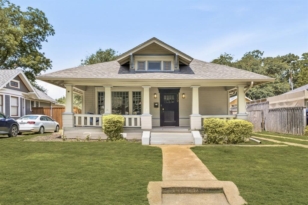 Welcome to this 4-bedroom, 3-bath prairie-style home in the heart of Historic Winnetka Heights. The inviting front porch overlooks a tree-lined street, while inside you'll find wood floors, two living areas, two dining spaces, custom cabinetry, large pantry and Carrera marble countertops. The kitchen opens to a second living area featuring a custom wet bar and easy access to the backyard, creating additional space for everyday living and entertaining. The functional two-story layout provides separation between living and private spaces. The private primary suite includes a walk-in closet, double vanities, a dedicated vanity area, and a soaking tub. Three additional bedrooms and two full baths provide space for family, guests, or work-from-home needs.  Conveniently located near the Bishop Arts District, neighborhood parks, local dining, and entertainment.