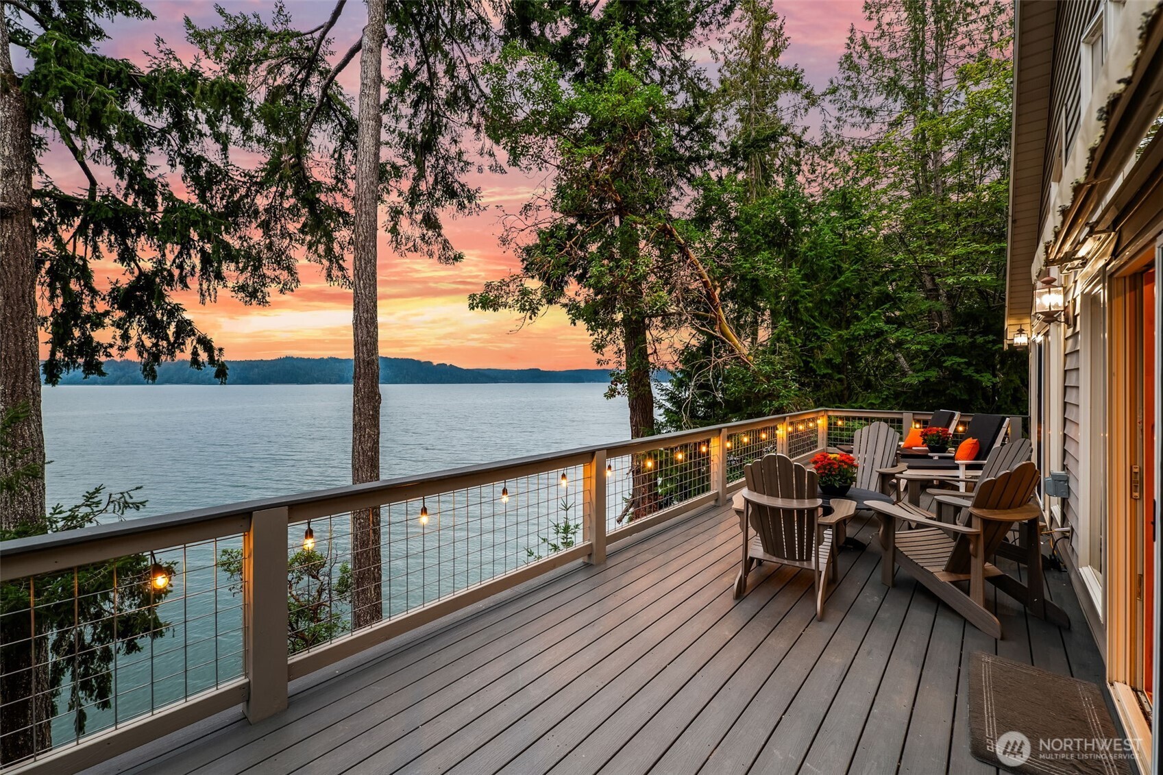 Perched on the pristine shores of Hood Canal, this custom chalet offers the perfect PNW escape. Crafted with intention; etched tile, hand-scraped floors, & locally sourced millwork, the home is as authentic as the tides it overlooks. Resting on .33 acres with owned tidelands & a private stretch of beach, it is surrounded by evergreens and natural beauty. Walls of windows frame stunning waterfront views, while the open great room flows to a new Trex deck ideal for entertaining. A proven short-term rental/Airbnb, this 2 bedroom has flex rooms plus smart home tech features, fiber-optic internet, efficient mini-splits, Milgard windows, and a durable metal roof. Harvest shellfish, float the canal, & savor the lifestyle of waterfront living.