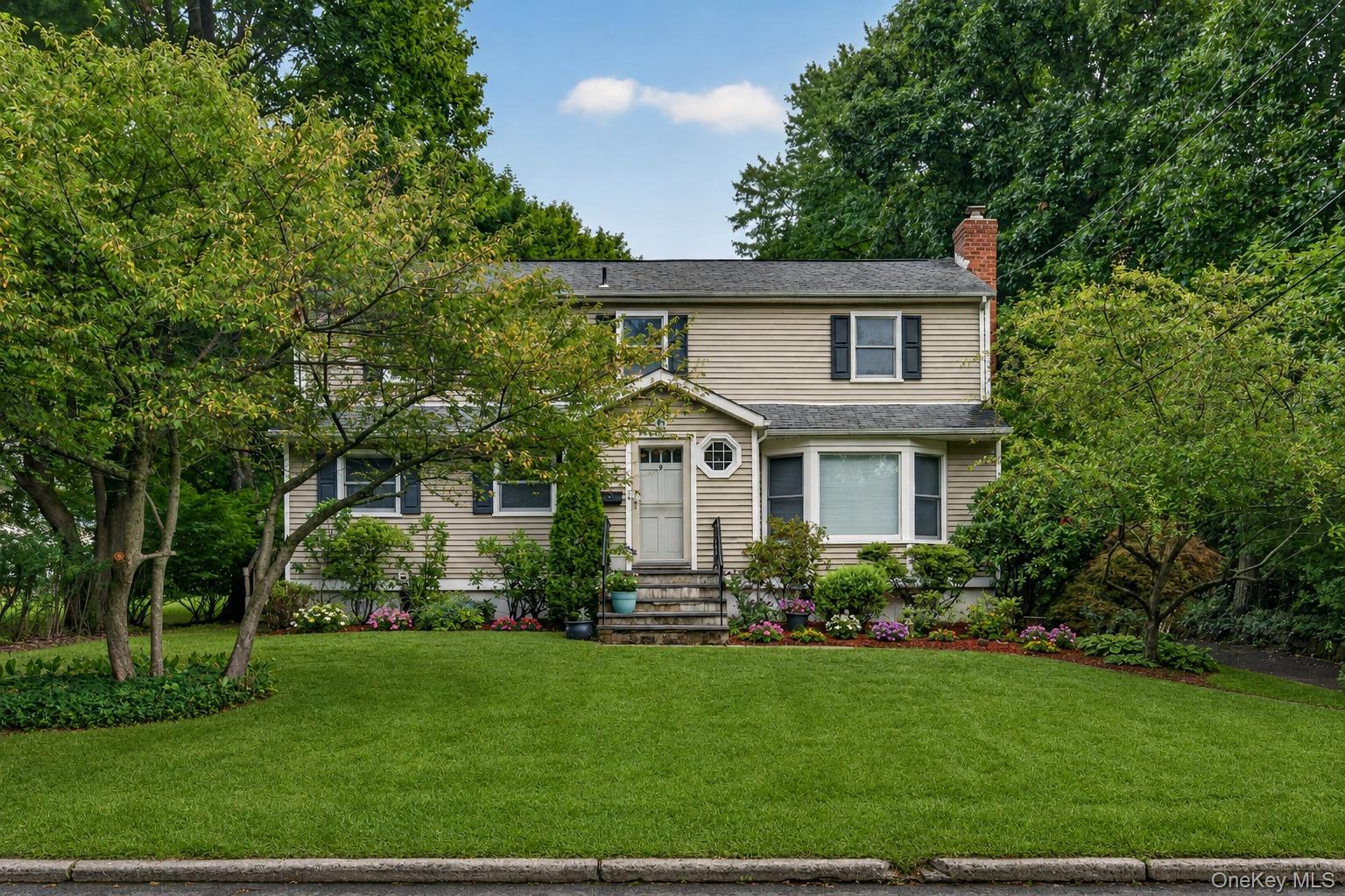 A fresh new look at 9 Verne Place! Freshly painted throughout with thoughtful cosmetic updates and refreshed landscaping, this well-maintained 4-bedroom, 2-bath split-level home has a clean, inviting feel and is ready for its next owner.Set on a quiet street in sought-after Poets' Corner, one of Hartsdale's most desirable neighborhoods, the home offers a flexible layout with a comfortable living room featuring a wood pellet stove for added warmth and efficiency, a dining area, and a kitchen with breakfast nook.  The upper levels include four bedrooms and two full baths. The finished lower level adds valuable living space with walkout access to the backyard, making it ideal for a media room, home office, or whatever best suits your lifestyle. A standout feature is the expansive, level backyard, offering plenty of usable outdoor space and endless potential for entertaining, gardening, or future improvements. Additional features include an attached one-car garage, generous storage, and close proximity to shopping, dining, parks, and transportation. Conveniently located just minutes from the Hartsdale Metro-North station with express trains to Grand Central in approximately 35 minutes. A wonderful opportunity to move right in, personalize over time, and make this home your own.