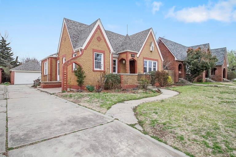 There is not a more striking Tudor Revival  historic cottage with its square turret and decorative brick pattern.  Bright and charming with 2 bedrooms and 1 bath.  Historic charm inside and out. Whimsical interior just makes you feel good.  Refinished hardwood, remodeled kitchen and bath.  Detached garage.  Privacy fenced back yard.  This is a turnkey STR and stays booked almost constantly.