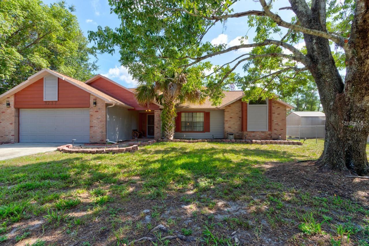 Welcome Home! BRAND NEW ROOF, BRAND NEW FENCE AND POOL PUMP. This beautifully updated 3-bedroom, 2-bath pool home is nestled in one of Deltona’s most desirable areas—backing directly onto a serene nature preserve, ensuring no rear neighbors—ever. Step inside and enjoy a spacious, thoughtfully designed floor plan featuring a formal living room, dining area, a cozy family room, and a desirable split-bedroom layout. The home has been extensively updated with: New tile and luxury vinyl flooring, new A/C system with UV light (2023), New water heater, new French doors and new kitchen appliances all in 2023, New septic system and drainfield (2016) New screen enclosure (2020). The kitchen is a standout, showcasing granite countertops, stainless steel appliances, and ample cabinet space. Both bathrooms have been tastefully remodeled, with modern fixtures, sinks, and the second bathroom featuring a full-size tub. Enjoy high, vaulted ceilings that add to the open feel of the home. Step outside to your private screened-in pool, perfect for relaxing or entertaining during Florida’s sunny seasons. Don’t miss the opportunity to own this move-in-ready home with comfort, privacy, and upgrades throughout!