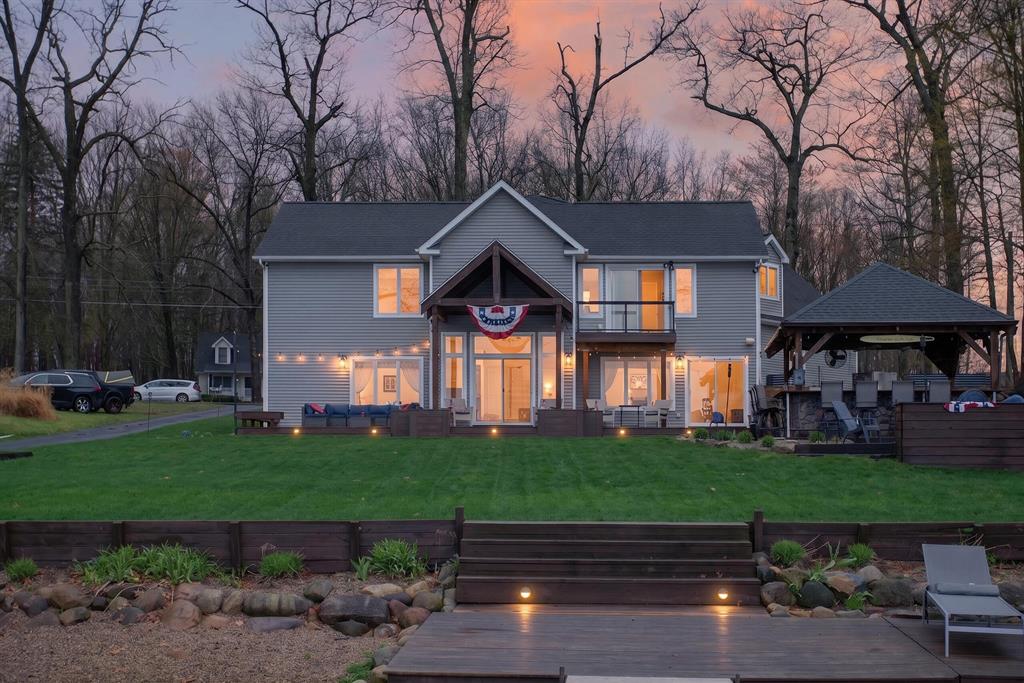 Built in 2007, this meticulously designed lakefront home blends timeless craftsmanship with modern efficiency, offering an elevated lifestyle on the desirable high side of Round Lake, known for its striking blue clarity. With 4 bedrooms, 3.5 baths, a huge bonus room, office, lakeside living room, family room & kitchen with walk in pantry you will have all the interior space you need for living & entertaining in the cooler months - but once the summer season hits your outdoor living space will be the star of the show with a fully equipped covered kitchen complete with flat top grilling, refrigeration, sink & bar area, patio with firepit, large deck, & private dock system at the lake's sandy, gradual shoreline which extends approx. 75 yards ideal for swimming, recreation, & year-round enjoyment. Rich cherry wood accents, solid wood custom-built stairs, railings, & trim showcase the home's superior quality and attention to every detail. MUST SEE TO APPRECIATE - TO MANY AMENITES TO LIST