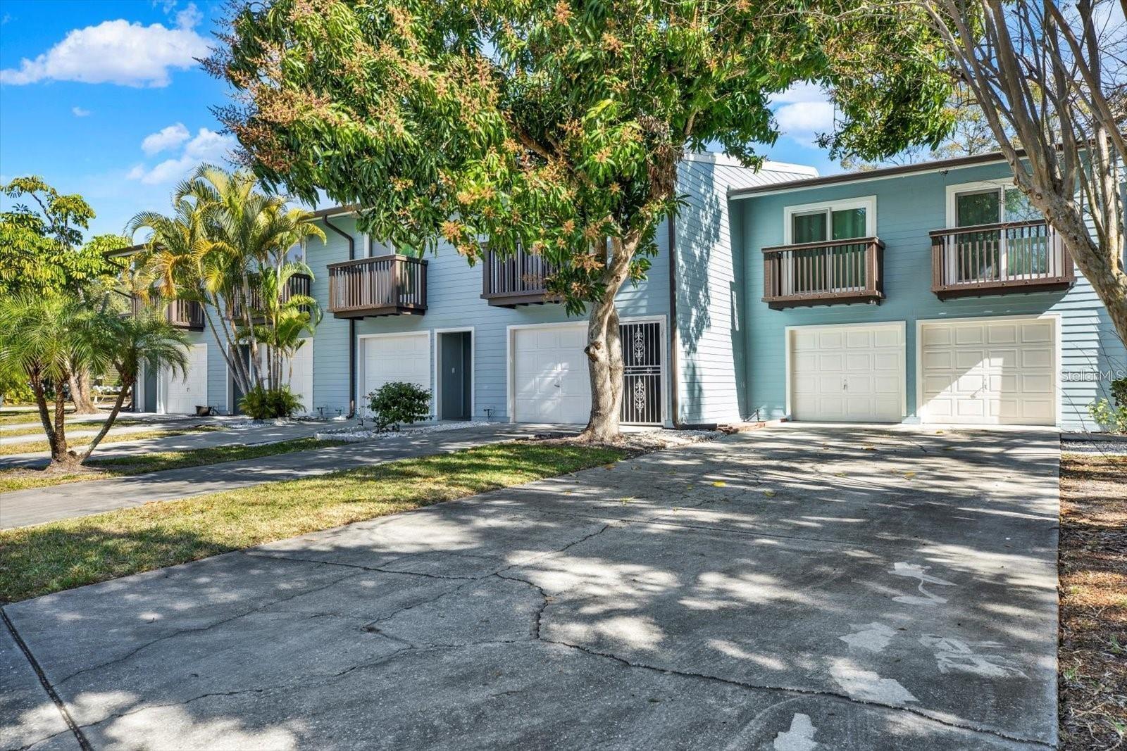 Welcome to Lake Forest, a hidden condo community tucked away in a lush, green oasis surrounded by neighboring equestrian beauty! This Bright, Inviting & Modestly Updated 2-bedroom, 1.5 bathrooms, tri-level condo with a bonus flex room downstairs perfect for a home office or gym and attached one-car garage for ultimate convenience and storage with additional guest parking only steps away. Relax on your screen-enclosed back patio year-round, and enjoy the frequent passing of the Horses walking along the trails. Pet lovers rejoice! This community is one of the few in the area that WELCOMES EXTRA LARGE DOGS (see HOA for possible Breed restrictions), and there’s even a dog park for large and small pups to run and play just across the street! Love the outdoors? You'll adore the miles of walking, jogging and biking trails right outside your door—plus, the city-owned green space across the street is protected from future development, ensuring your tranquil surroundings stay just as they are! Lake Forest offers a relaxed and comfortable lifestyle, HIGH & DRY NON FLOOD ZONE, with pristine amenities including a sparkling pool, heated spa, a tranquil estuary is a welcomed host to an abundance of local wildlife as well as our seasonal visitors and just across the street racquetball, pickleball, and fun Zumba classes, as well as families will love the affordable childcare options, with before & after-school programs and summer sessions just steps from home. Plus, with the HOA covering cable/high-speed internet, water, sewer, trash, recycling, exterior maintenance, roof, and grounds you can truly enjoy maintenance-free living! Perfectly located with an easy commute to Tampa, St. Pete, Airports and Award Winning beaches! Don’t miss out—schedule your private showing today!