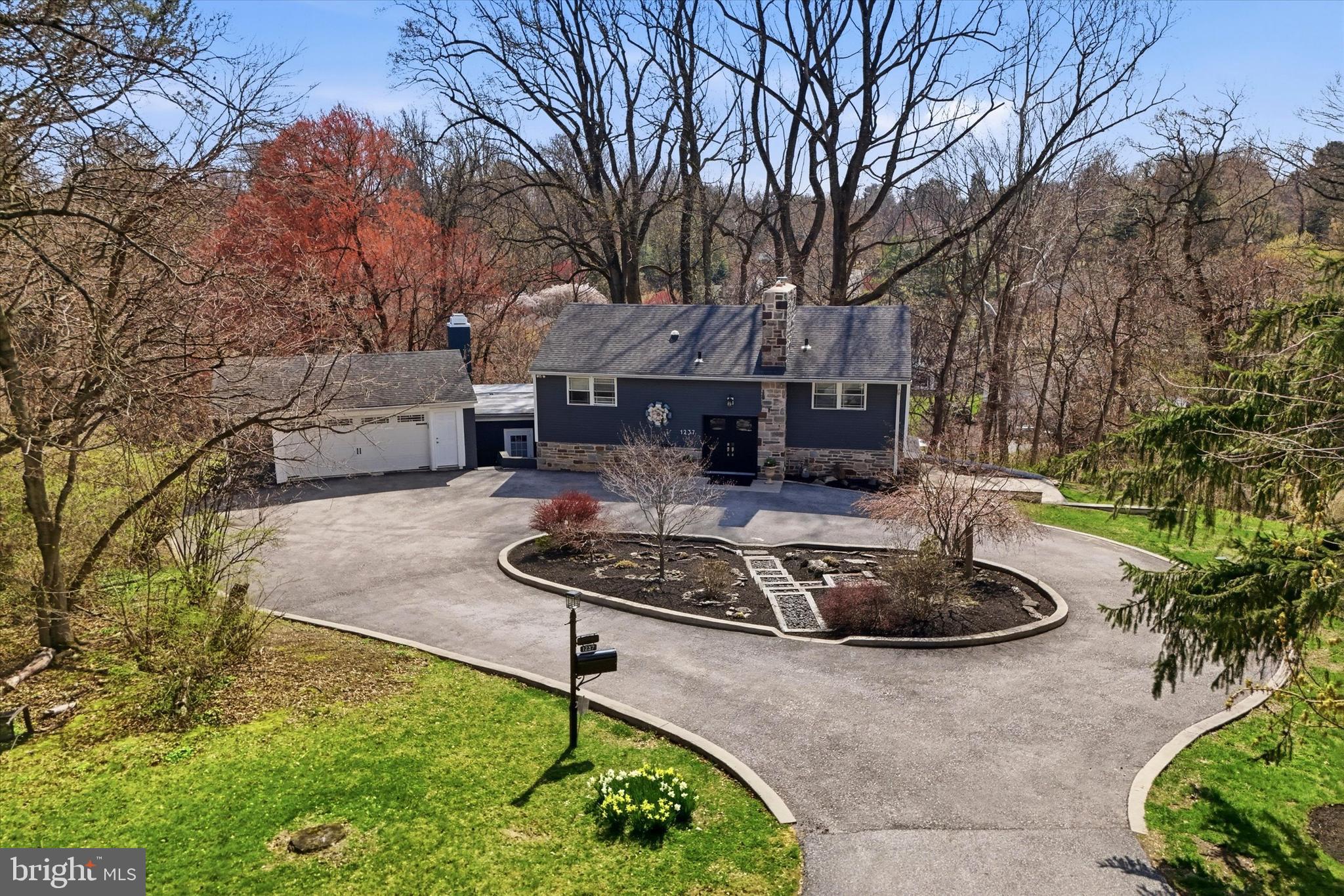 Set on landscaped grounds, this home offers a serene, private setting at the end of a long drive and provides a peaceful escape on over an acre in the heart of Penn Valley and the highly sought-after Lower Merion School District. This 3-bedroom plus den, 2.5-bath home offers the perfect combination of comfort & luxury with sought-after Main Line conveniences, and is walking distance to school and places of worship and has easy Center City access.The spacious and functional layout is designed for everyday living and seamless indoor/outdoor entertaining. The home offers beautiful tree-top views and sunlight fills the main living areas, creating a warm and inviting home.The show stopping kitchen is the heart of this home,  complete with a large seated island, a coffee nook and wine bar with wine refrigerator, custom cabinetry, and generous prep space, as well as a huge walk-in pantry.  High-end stainless steel appliances including cooktop with griddle and professional hood, double wall ovens, convection microwave and warming drawer will please the most discerning chef.  A side-by-side Sub-Zero refrigerator and freezer makes for an abundance of storage for all of your entertaining needs.  All opening seamlessly to the dining room and the family room with sliding glass doors opening to the screened porch & back yard. An inviting den is tucked off the family room- with built-in bookshelves and a gas fireplace-  It's the perfect work from home space or a cozy place to curl up with a good book. Additional flexible living spaces include a separate gym area, which would make a great home office as well, perfect for today’s work-from-home and wellness-focused lifestyles. Whether you need space for productivity or recreation, this home delivers versatility to meet your needs.The laundry room as well as the convenient powder room and separate mudroom entry complete this level.Upstairs, the large primary suite offers a true retreat, complete with a luxurious en-suite bath with double vanities, an oversized shower with dual shower heads and benches and an enormous custom outfitted  walk-in closet with island storage. Two additional well-sized bedrooms share a beautifully appointed hall bath with dual sink vanity & shower/tub combo with eye catching tile work throughout. The home offers indoor/outdoor seamless living with the screened-in porch that spans the length of the main level, and the paver patios and hot tub are in the perfect tranquil backdrop for relaxing or entertaining.  Enjoy the covered porch or the large outdoor patio with BBQ, or soak in the hot tub and take in the peaceful surroundings. Just minutes from Center City Philadelphia, major roadways, and top-rated Lower Merion schools, this Penn Valley home offers indoor/outdoor living with luxury finishes. A wonderful opportunity to own in one of the Main Line’s most desirable communities with all the conveniences of the Main Line, shopping, dining and more.  Enjoy close proximity to center city Philadelphia and the close proximity of the train.