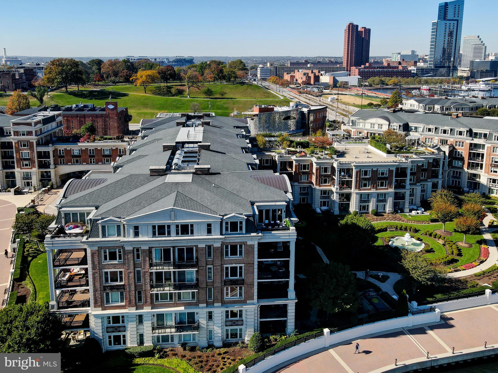 Step into one of the most distinctive and thoughtfully reimagined homes ever offered at The Ritz-Carlton Residences in Baltimore. This fully reconstructed, custom-designed penthouse spans over 5,400 square feet on a single floor, offering panoramic views of the harbor, rare design elements, and unmatched privacy in the city’s most prestigious address.  Unlike the typical builder models, this residence underwent a complete transformation, from floor plan to finish, resulting in a truly bespoke living experience. The grand living room is crowned by a hand-painted, 30-foot mural with gold and silver leaf accents, turning the space into a breathtaking gallery of art and architecture. Adjacent, a silver-leaf ceiling floats above the formal dining room, grounded by elegant marble flooring and illuminated by a modern crystal drop chandelier imported from Portugal, which casts a soft, refractive glow and adds a sculptural focal point to the space. The chef’s kitchen is a bold expression of form and function, with gleaming quartz countertops, herringbone wood floors, and mirror-polished stainless steel upper cabinetry and hood. Designed with effortless entertaining in mind, it features double islands with bar seating, top-tier Sub-Zero and Wolf appliances, and a discreet scullery-style prep kitchen that keeps the main space pristine without interrupting the flow of hospitality. Throughout the residence, polished nickel hardware and fixtures create a cohesive and elevated aesthetic, complementing the home's finishes with timeless sophistication. Smart-home automation allows for complete control of lighting, shades, temperature, audio, media, and access, all seamlessly operable from within the home or around the world. The primary suite is a tranquil escape, with its own private sitting area and terrace access overlooking the marina and outer harbor. The ensuite bath features a spa-inspired steam shower with both rainfall and wall-mounted showerheads, a generous soaking tub, a TOTO Neorest bidet, and refined finishes that blend luxury with serenity. The boutique-style dressing room is softly illuminated and impeccably appointed, rivaling any high-end showroom. Two additional ensuite bedrooms provide privacy and flexibility, while a stylish media room and multiple living zones offer space to relax, recharge, or host in style.  All four bathrooms are equipped with Toto Norest bidets and all exterior windows and doors are new.  The two private terraces frame the city skyline and entire harbor, perfect for morning coffees, sunset gatherings, or simply watching the waterfront come to life.This penthouse is accompanied by a rare offering of five parking spaces with two reserved private garage spaces steps away from the personal elevator and three additional valet-access spaces, ensuring convenience for both owners and guests. Residents enjoy exclusive access to on-site fine dining, a full-service marina, and a state-of-the-art medical and wellness spa, along with 24/7 concierge, valet, doorman, and porter services that define the Ritz-Carlton standard. Additional lifestyle amenities include an indoor pool, fitness center, theater, six private guest suites, and elegantly appointed event and entertaining spaces nestled within manicured gardens. Perfectly positioned on the Baltimore Promenade, with direct access to the waterfront, water taxis, and cultural landmarks, this home is just minutes from the city’s art scene, stadiums, Penn Station, and BWI Airport. This is not just a residence- it is a one-of-a-kind masterpiece of bespoke design, technological innovation, and refined waterfront living. Schedule your private showing today.