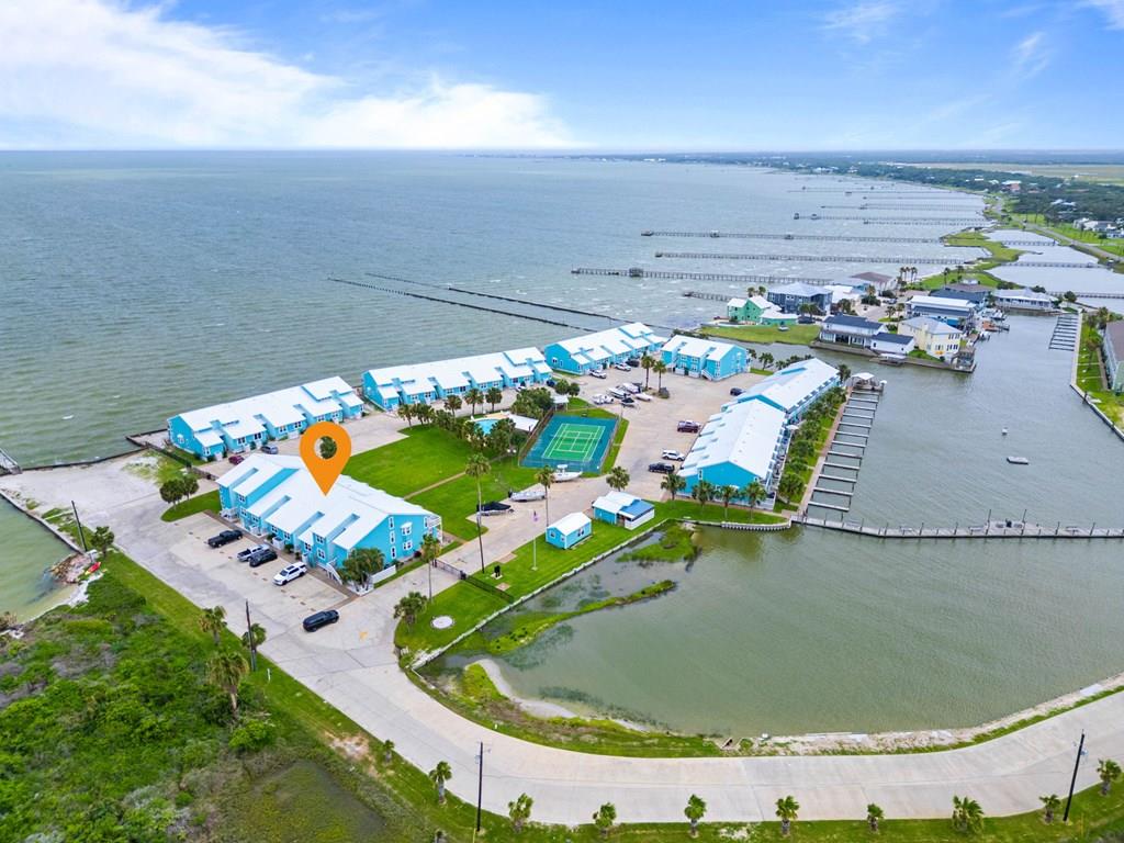 Welcome to coastal living at its finest!  This beautifully upgraded 2 bedroom, 2 bathroom condo with a BONUS ROOM at Bayfront at Kontiki Condominiums offers breathtaking water views and the perfect blend of comfort, style, and coastal charm.  Sold fully furnished, this move in ready retreat features granite countertops, stainless steel appliances, tile and vinyl plank flooring, and an open concept layout designed to maximize the stunning views.  Enjoy your morning coffee or evening sunsets from the spacious upper and lower decks.  Whether you are looking for a full time residence, vacation getaway, or investment property, this condo checks all of the boxes.  Current owners have two twin beds, a high definition television, and an owner's closet in the bonus flex space.  Short and long term rentals are allowed, offering flexibility and income potential.  Kontiki's resort style amenities include a community pool, pickleball courts, boat slips, boat parking, boat ramp, bayfront and canal fishing piers, and some of the best fishing on the Texas coast.  Don't miss this opportunity to own a slice of paradise with spectacular views, outstanding amenities, and endless waterfront recreation right outside your door!