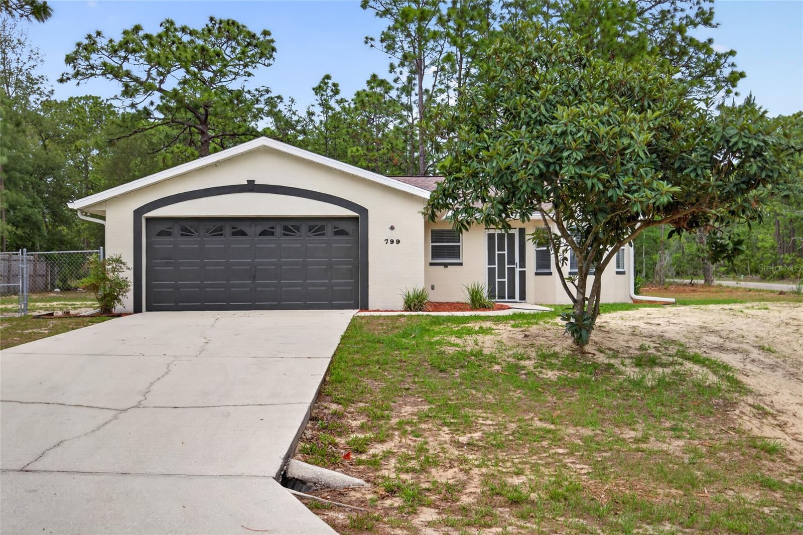 Turn-Key & Move-In Ready in Citrus Springs! Don't miss this beautifully updated 3-bedroom, 2-bath, 2-car garage home situated on a fully fenced 87 x 125 corner lot. Freshly painted inside and out, this home features brand-new 7MM thick waterproof laminate flooring throughout with no carpet anywhere. The chef's kitchen impresses with new real wood soft-close cabinets and drawers, Arctic White quartz countertops, and a new stainless steel Frigidaire appliance package backed by a 1-year manufacturer's warranty. The open floor plan with soaring vaulted ceilings and 8 windows with a double French door in the living area floods the space with natural light. Updates continue throughout with brand-new interior doors, blinds, toilets, and bath vanities, making this home truly move-in ready from top to bottom. Step outside and enjoy the 10 x 15 screened porch, perfect for relaxing or entertaining while taking in the Florida weather. Major mechanicals are already done for you: energy-efficient AC installed December 2025, roof replaced in 2020, and a brand-new nitrogen-reduction drainfield just installed. Located on the south side of Citrus Springs, you're just minutes from shopping, dining, and the new Sun Coast Parkway entrance for an easy commute to Tampa.