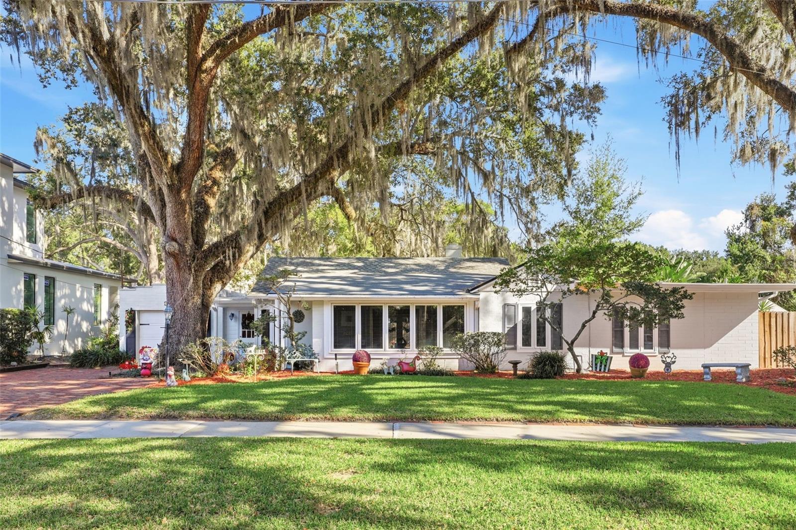 LOCATION LOCATION LOCATION!!!  This College Park charmer is waiting for its new owner.  As you enter this beautiful, two bedroom two bath bungalow you walk into a sun porch with loads of light. Continue through the house into the spacious dining room and living area which features beautiful Birch flooring, high ceilings with beam architectural details and a built-in wall shelving unit. The updated kitchen has granite countertops, stainless steel appliances, gas range, breakfast bar and light cabinetry.  Off the kitchen is a nook area with a built-in desk and cabinets.  As you continue to the back of the house there is a large family room with wood ceilings with beautiful beams and French doors leading to the backyard and to the screened porch Skylight and large windows bring in loads of light.  The primary suite is oversized and allows for a separation of space for an office, gym equipment or just a separate sitting area to nestle and read. The primary bathroom has been updated with custom vanity and tiled standup shower. The guest area has a second bedroom and updated bathroom. Outside is a beautiful large fenced yard with a workshop.  The screen patio is spacious allowing for outdoor entertaining. This beautiful home is a block away from gorgeous Lake Ivanhoe and is waiting for its new owner.  HVAC 2025, Shingle Roof 2019, Flat Roof 2023.