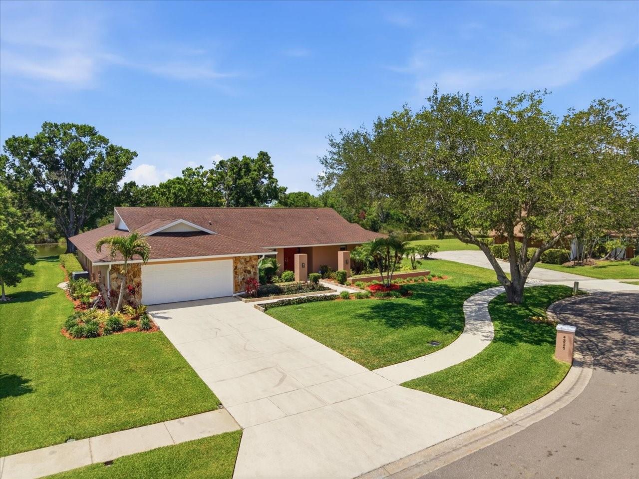 Welcome to this exceptional Carrollwood Village residence offering over 3,100 square feet of thoughtfully designed living space. This 3-bedroom, 3-bathroom home features a desirable split-bedroom floor plan and a spacious 3-car garage, all set against a backdrop of serene pond and conservation views. The layout is ideal for both everyday living and hosting guests, with two secondary bedrooms situated on the west wing sharing a full bath with convenient pool access. A separate guest suite on the opposite side of the home offers privacy with its own ensuite bath and walk-in shower. The primary suite is a true retreat, showcasing tranquil pool and water views along with a custom Roman-style soaking tub for a spa-like experience. Step outside to your private oasis, where a sparkling screened-in pool, outdoor bar, and lush natural surroundings create the perfect setting for relaxing or entertaining. Enjoy peaceful mornings and stunning sunsets overlooking the pond and conservation area—this is Florida living at its finest.