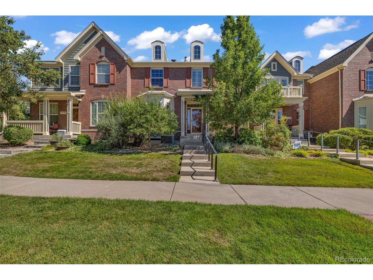 Welcome to 14295 W 84th Pl, in the heart of Village of Five Parks.At 3,388 total square feet, with 2,282 of it above grade, this townhome lives much larger than the number suggests. The main level primary suite is what sets it apart, letting you live comfortably on one floor while the rest of the home stays open for family, guests, or working from home. An open living area with a fireplace flows into the kitchen, which comes complete with the range, refrigerator, dishwasher, and microwave and opens to a private back patio made for morning coffee. Four bedrooms and three baths in all. Downstairs, the fully finished basement adds another 1,106 square feet and works beautifully as an in law suite for extended family or long term guests, or a flex space that can be used as a gym, home office, or media room.This is an original owner home, built in 2007 and cared for by the same family every day since. No rushed flip, no cut corners, and the condition speaks for itself. The interior was professionally repainted this month, the carpets and entire home professionally deep cleaned, and every window washed inside and out. The expensive items are handled too. The roof includes a heated section that melts the snow off automatically. The furnace was replaced in 2024, the water heater in 2022, and a radon mitigation system is already installed. Central air, forced air heat, and an attached two car garage round it out.The HOA covers all exterior maintenance and includes the community pool, fitness center, and clubhouse, so your weekends stay yours. Village of Five Parks is one of Arvada's most walkable neighborhoods, with parks, trails, and the village center close by and quick access to Olde Town Arvada, Boulder, and downtown Denver.Move in ready today. Homes cared for like this one do not come up often here!