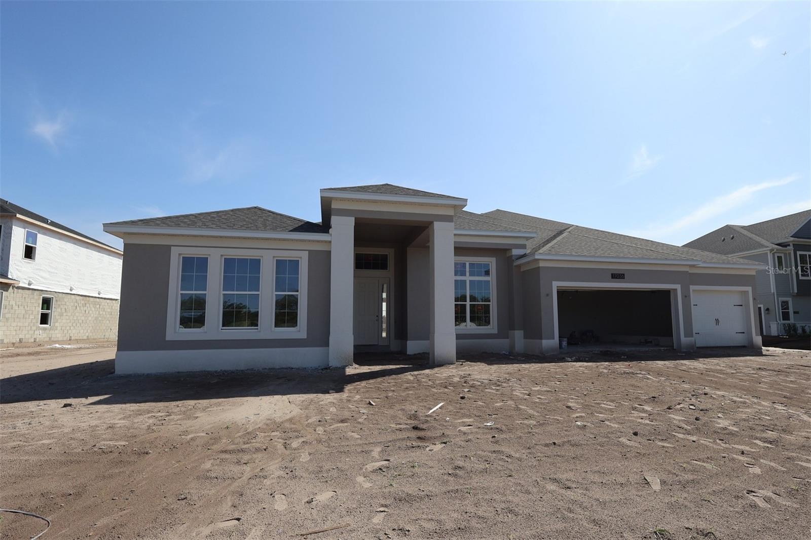 Under Construction. This 4,530 square foot home offers 4 bedrooms, 3 ½ baths, and features a formal dining, living room, volume ceilings, and a 3-car garage.The dramatic foyer has tall tray ceilings, accented with archways and half walls that see through to the shared living spaces. The open-concept kitchen features stunning cabinets, an oversized kitchen island, a walk-in pantry, and separate breakfast area. The spacious family room leads to the covered lanai.The bedrooms are split to maximize comfort and privacy; one bedroom with an en-suite bath is in the front of the home, while two additional bedrooms share a hall bath on the other side of the home behind the kitchen. Your owner’s suite is tucked away on the other side of the family room. All the secondary bedrooms have walk-in closets!The luxurious owner’s suite with a double door entry offers a tray ceiling, tons of natural light, and two large walk-in closets. The en-suite bath showcases a separate soaking tub and oversized walk-in shower, two vanities, linen storage, and private water closet.