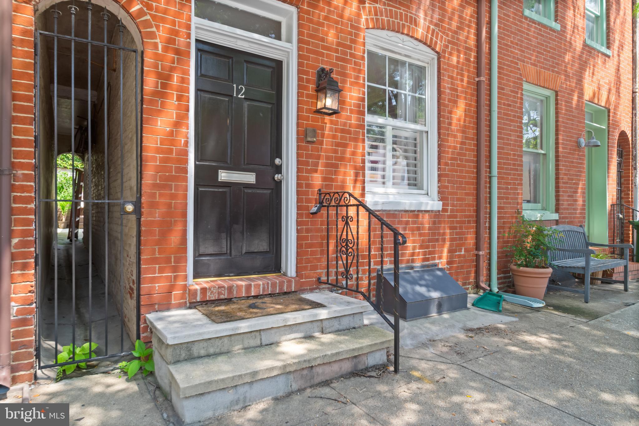 Move-in ready RENTAL townhome featuring 3BR/2BA with tons of charm and character located on a tree-lined street in Federal Hill! Step inside to a home filled with natural light, original hardwood floors, an exposed brick wall, an exposed wood beam ceiling, original cast iron radiators, and a decorative fireplace. The main floor offers a large living room, dining room, kitchen with plenty of cabinets, granite countertops, stainless steel appliances, and a garden window above the sink. The second floor features two sizable secondary bedrooms and a full bathroom. The 3rd floor has your primary bedroom with a private full bathroom, and sliding doors to a private balcony. From the kitchen make your way to the fenced yard with an oversized deck surrounded by foliage. This home is move-in ready with street parking  and in close proximity to all that downtown Federal Hill offers!