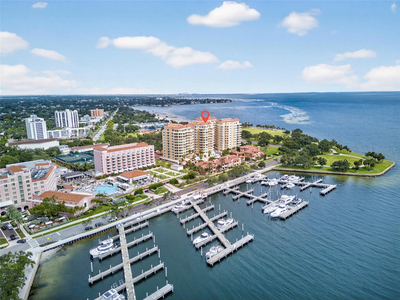 LUXURY LIVING AT VINOY PLACE WITH ONE OF THE LARGEST WRAPAROUND TERRACES IN THE COMMUNITY! Experience the best of downtown St. Petersburg in this exceptional residence, offering expansive outdoor living with stunning city skyline views, glimpses of the Vinoy Basin, and views overlooking the resort-style pool. A private elevator opens directly into your own foyer, welcoming you into a bright, spacious floor plan filled with natural light and walls of windows. BRAND-NEW FLOORING THROUGHOUT, including gorgeous wide-plank French oak floors and modern marble-look tile in the kitchen and bathrooms, adds a fresh, sophisticated touch. The gourmet kitchen features premium Sub-Zero and Viking appliances, abundant cabinetry, and casual dining space. The versatile Vinoy Room is perfect for a den, media room, or home office. The spacious primary suite offers a private terrace, custom walk-in closet, and spa-inspired bath with soaking tub and separate shower. A second en suite bedroom, powder room, and dedicated laundry room complete the layout. Additional highlights include a whole-home water filtration and softening system, exceptional storage, two assigned garage parking spaces, and the convenience of your own private trash chute located in the elevator foyer. Vinoy Place offers 24-hour staffed gated security, two pools, outdoor kitchens, fitness center, club and game rooms, on-site management, and guest parking. JUST STEPS FROM BEACH DRIVE, THE ST. PETE PIER, WATERFRONT PARKS, RESTAURANTS, AND MUSEUMS! With its extraordinary wraparound terrace, private elevator entry, and unbeatable downtown location, this residence offers a truly exceptional luxury lifestyle.