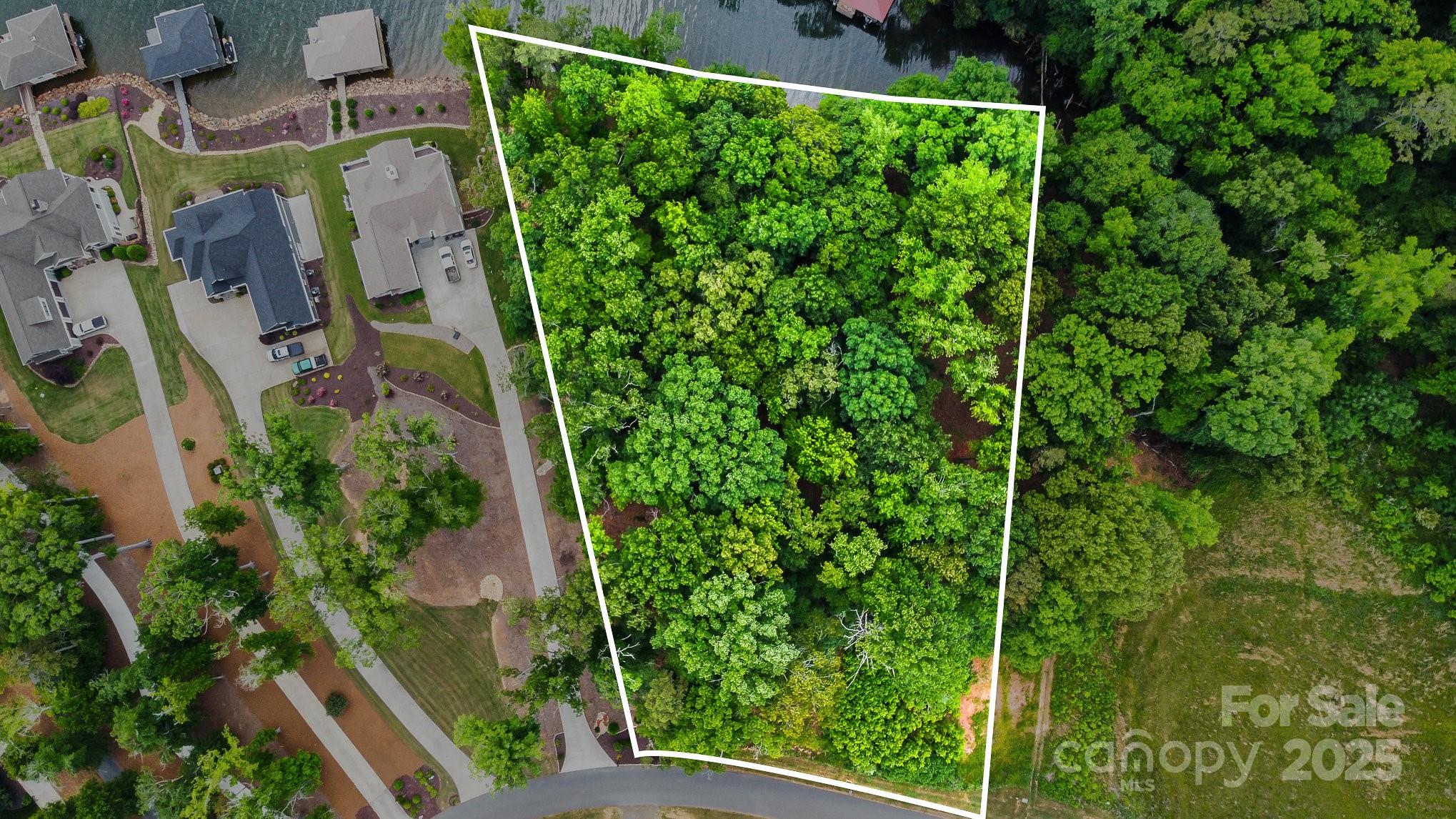 Beautiful waterfront lot on lake Tillery in gated community. The +/- 1.14 acre lot is situated in a small cove that opens to the main channel. This lot is located in an area that allows a boathouse, however, buyers should verify with Duke Energy about the lease and size of the boathouse permitted.