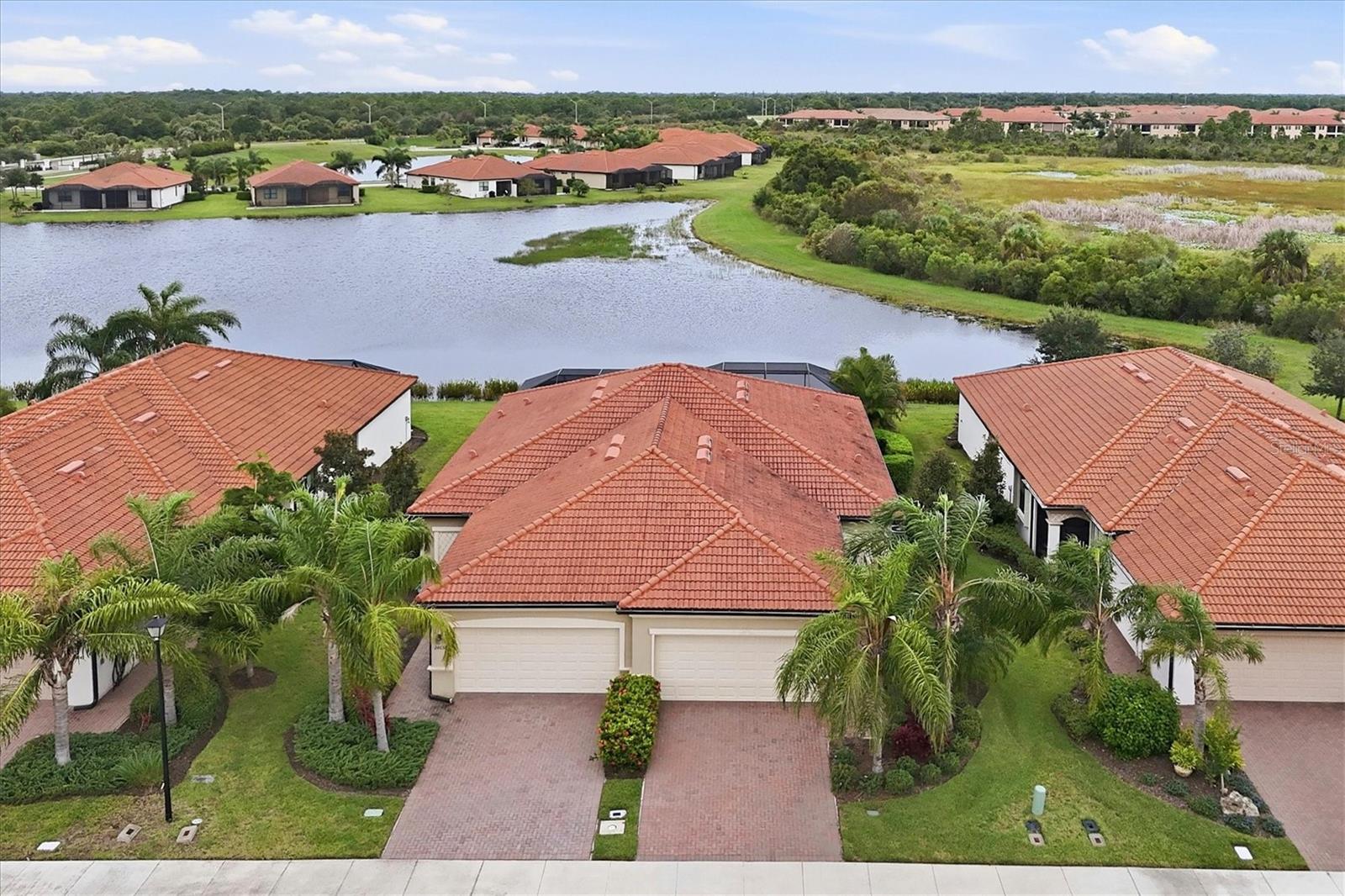 MUST SEE NOW! RARELY AVAILABLE IN SARASOTA NATIONAL!  The perfect living size for snowbirds and buyers downsizing.  This 3BD/2BA villa has 2 car garage,PRIVATE POOL, LAKE/PRESERVE VIEWS and it comes FURNISHED AS SEEN. Very few villas in Sarasota National have this floor plan. PLUS,  HURRICANE WINDOWS so no struggles to put up shutters or find someone to do it. This immaculate home has been lovingly designed and taken care of.  Kitchen offers GRANITE COUNTERS, UPGRADED STAINLESS STEEL appliances, backsplash, crown molding, recessed lights and over/under cabinet lighting.  Pass through to dining and living area allows everything to flow seamlessly. Main living areas have PORCELAIN tile flooring while bedrooms have carpet. Crown molding. Walk through the generous living area to the lanai and PRIVATE POOL. Not talking about some rinky dink little spa sized pool,  this is a full sized pool surrounded by pavered lanai. FACING WEST,  you will get full sun from South and West all day long.  You will also, have those GORGEOUS SUNSET VIEWS.  Don't feel like the sun?  Roll out the AWNING to block the sun and sit in the shade. Master bedroom has en suite bath offering dual sinks and walk in shower. Guest bedrooms and guest bath located at opposite end for privacy. Middle bedroom currently uses as a den, could also be an office.  Sarasota National is a VIBRANT AND ACTIVE community with over 1300 acres designated for preservation, conservation, lakes, and open space with amazing views, Proclaimed as an Audubon International Certified Sanctuary, making it the most gorgeous and enjoyable golf course to play at in the area. Offering resort style amenities with huge resort style pool and spa,Tiki Bar to serve refreshing drinks and a bite of lunch, tennis courts, pickle ball, Bocce courts, coffee lounge/library/card room/meeting place, 7000 sq ft fitness facilities offering classes and day spa, and a 30,000 sq ft Clubhouse with dining and spectacular views. 18 Hole championship golf course surrounded by native wetlands and preserves provides an exhilarating and dramatic back drop for your golfing adventure. Minutes away from the new Wellen Park shopping area and Atlanta Braves stadium. Venice Beach and Venice Downtown are just a short drive. Your choice of restaurants and outdoor activities await. DON'T MISS OUT! GRAB THIS BEAUTY BEFORE IT IS GONE and start LIVING YOUR FLORIDA LIFESTYLE.