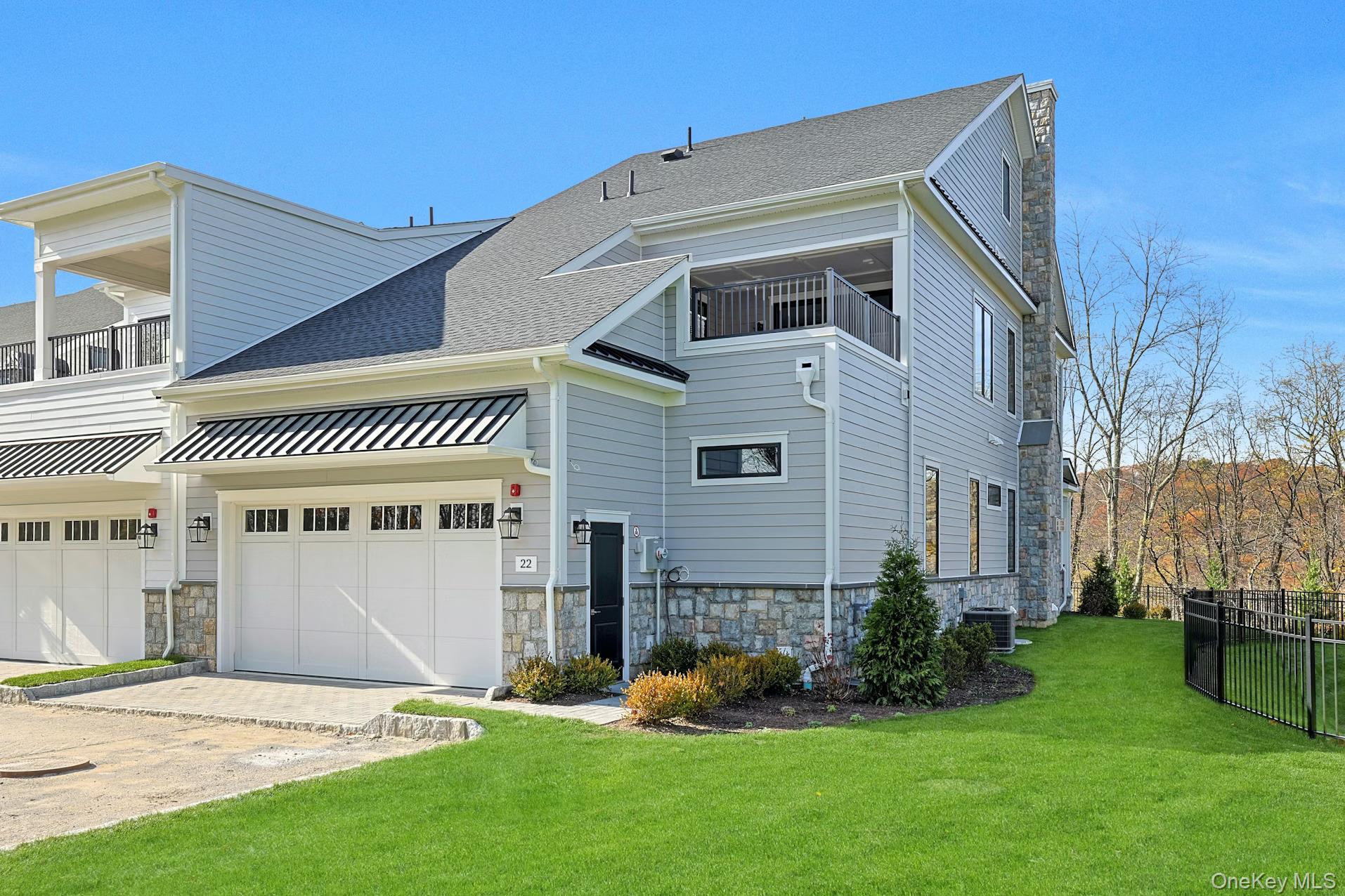 Introducing a stunning, contemporary, brand-new, lavish, luxury townhouse at sold-out Chappaqua Crossings. This coveted end unit sits on an ultra-premium lot with exquisite, wooded views and privacy on all three sides. Designed for discerning modern living, this home features a first-floor primary suite, rooftop deck with outdoor kitchen, and a fully finished basement with gym/media room, wet bar and custom wall treatments.  The inspirational great room has soaring 20-foot ceilings with custom paneling and a linear gas fireplace with granite surround. The sleek chef’s kitchen includes euro-style cabinetry, custom lighting, a waterfall island, Sub-Zero refrigerator, and other premier appliances. The dining room and primary suite feature custom paneled walls with designer lighting. The primary suite also offers a spa-like bath with lighted vanity mirrors, under-cabinet illumination and a large walk-in closet with motion sensor lighting. The stunning second floor loft overlooking the great room has a spacious entertainment area. wet bar with designer tiling and shelving, wine cooler, a bedroom with full bath, office/den, and an outdoor terrace with grill. The lower-level features herringbone engineered wood floors, designer wall paneling, a wet bar, flexible gym/office, full bath, and ample storage. Unit is pre-wired for sound and TVs, and has an elevator to all 3 levels, epoxy treated garage floors, extra electric/floor outlets throughout, pre-wired for car charger, stair lights, ADT security alarm system, security cameras, and internet service.  Community amenities include a clubhouse, playground, swimming pool, and a shuttle to train and town. Walk to shops, grocery store, dining, fitness club, theater, banks, and enjoy award-winning Chappaqua schools.